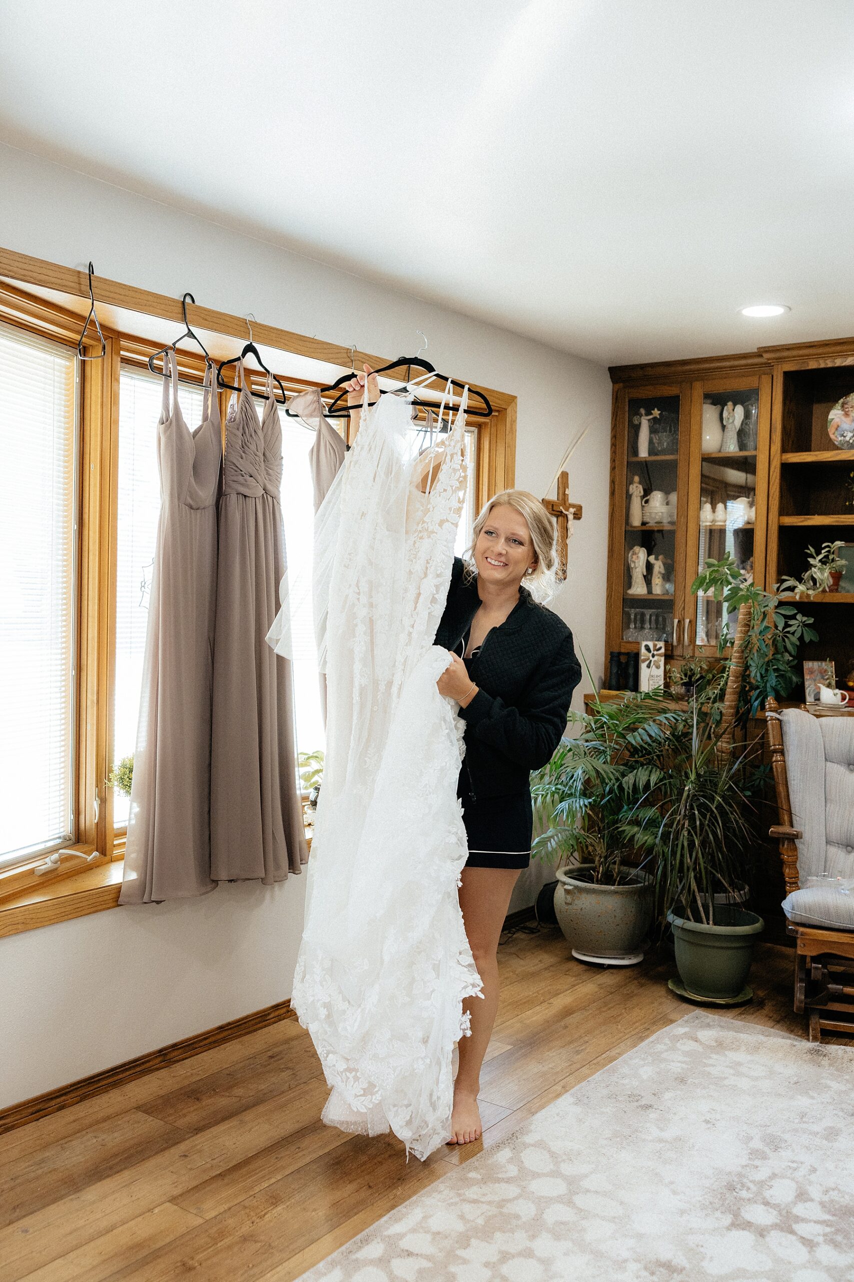 The bride grabbing her dress to go get dressed.