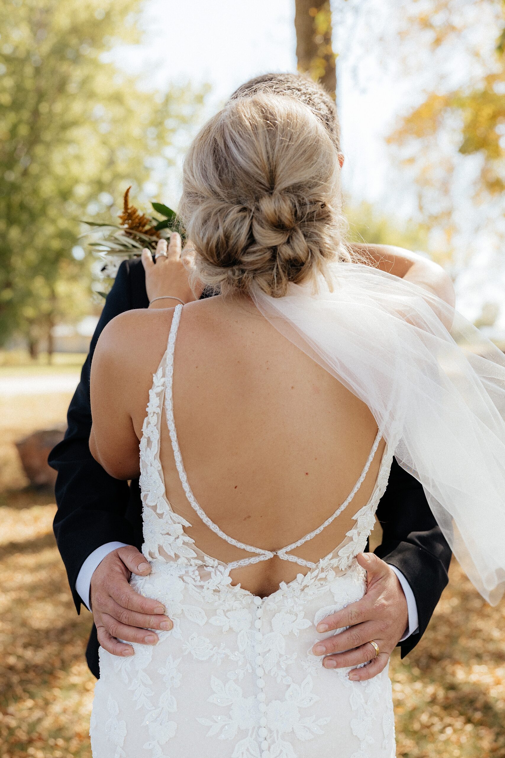 The groom with his hands on the bride's waist.