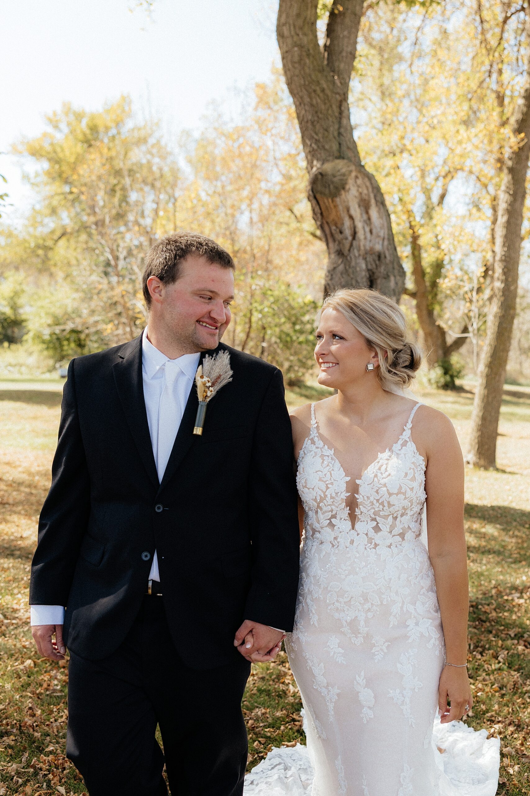 Dylan and Lindsey smiling at each other on their wedding day before the ceremony.