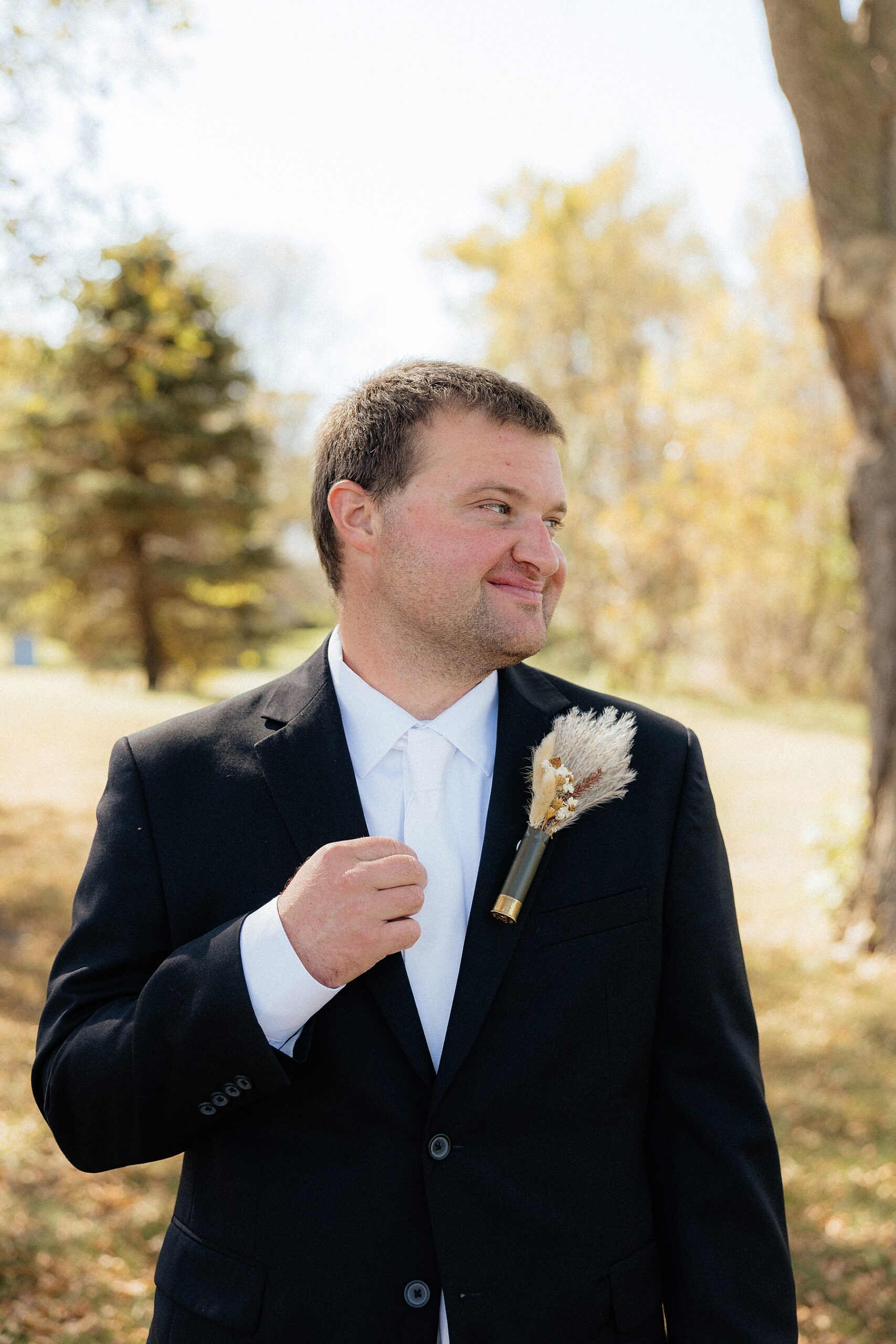 Broom adjusting his suit jacket.