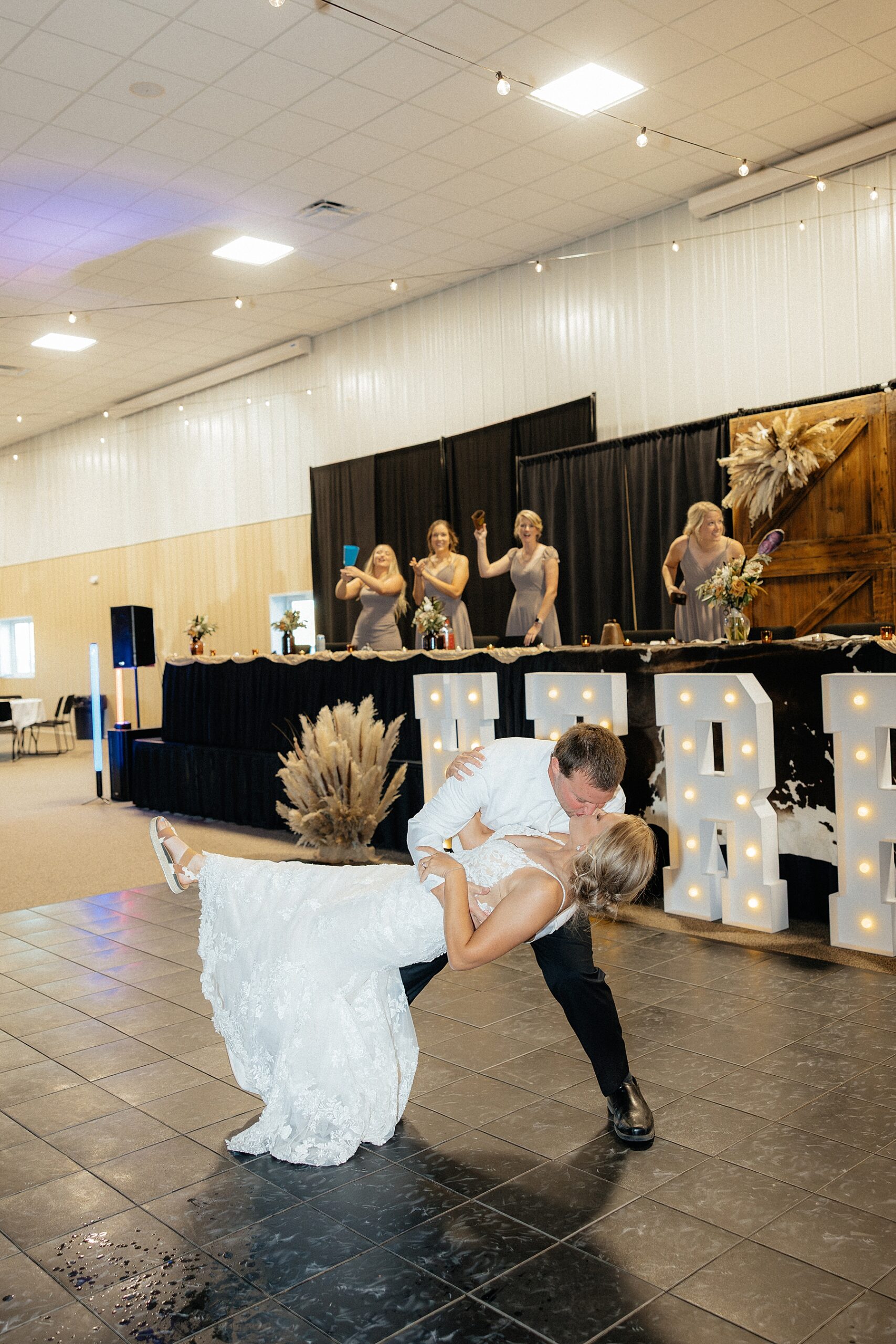 The groom dipping the bride at their grand entrance to the reception.