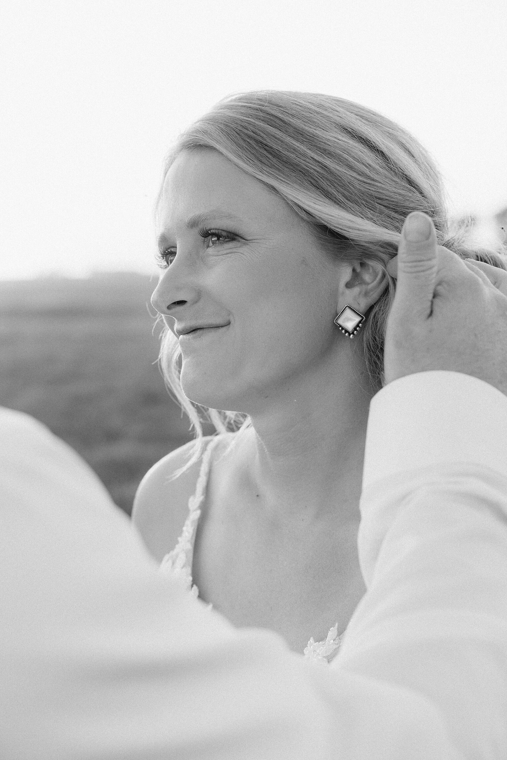 The groom showing off the bride's earrings.