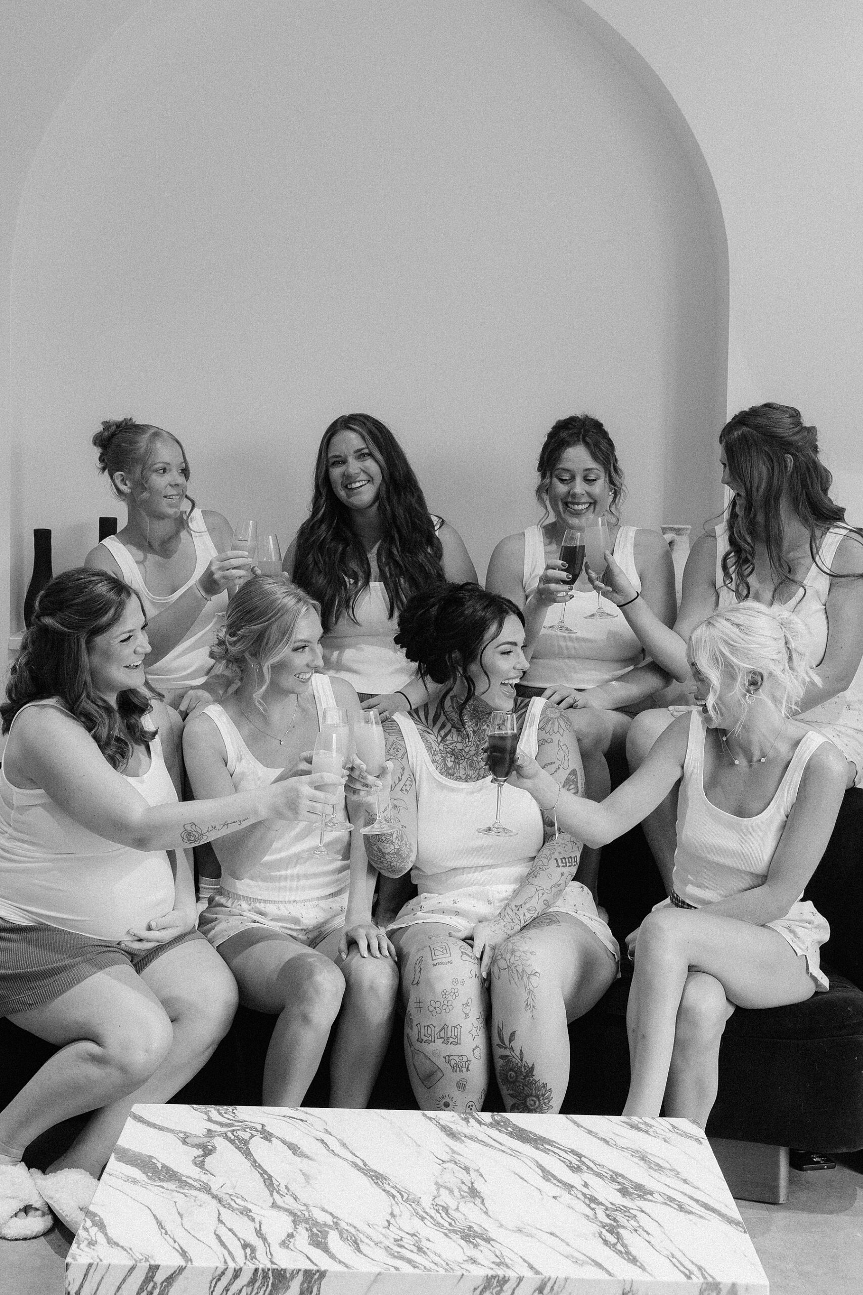 The bride cheersing her bridesmaids.