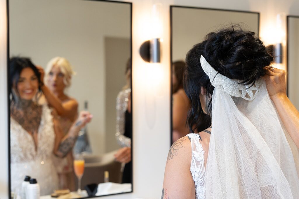 The bride having her vintage veil put in.