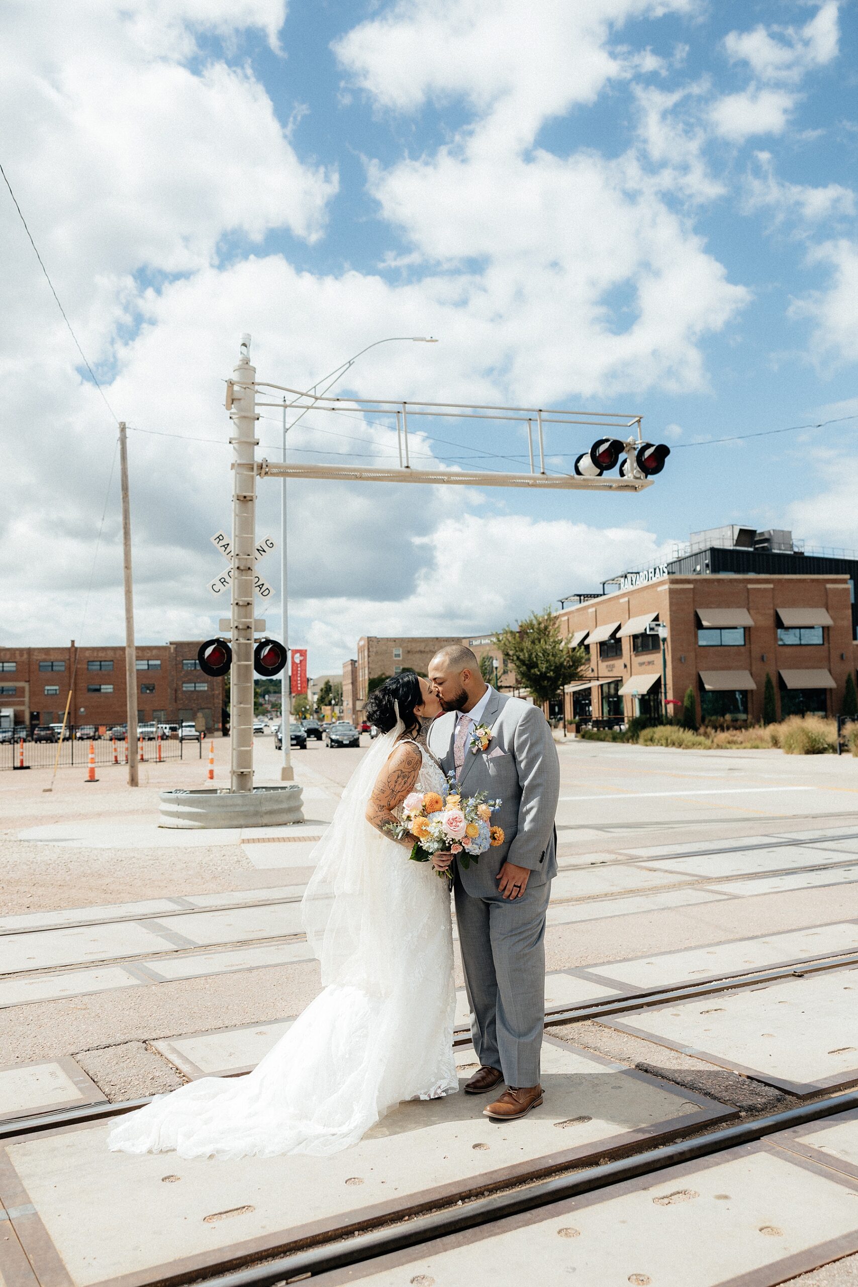 A couple standing at the railroads in Monick Yards.