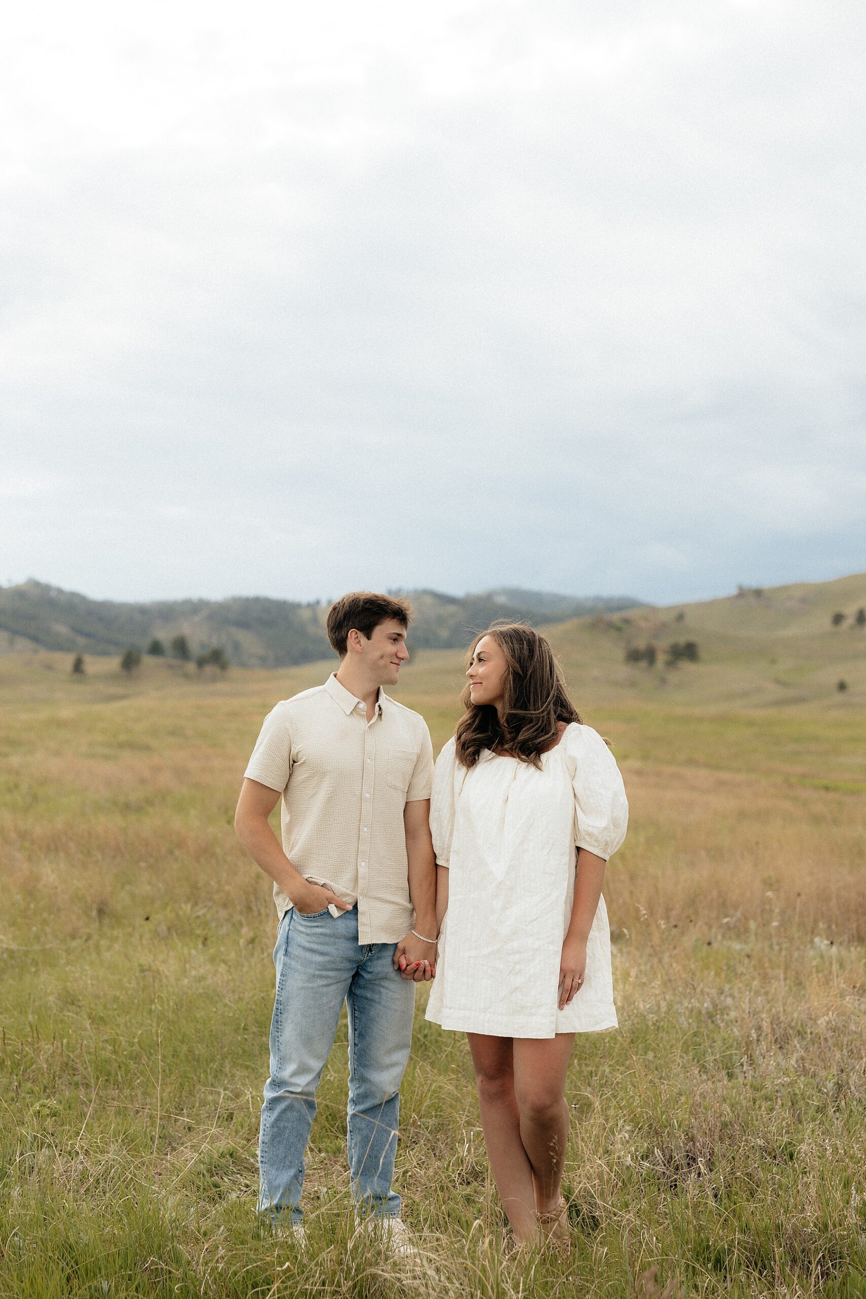 Christian and Olivia looking at each other during their South Dakota engagement session.