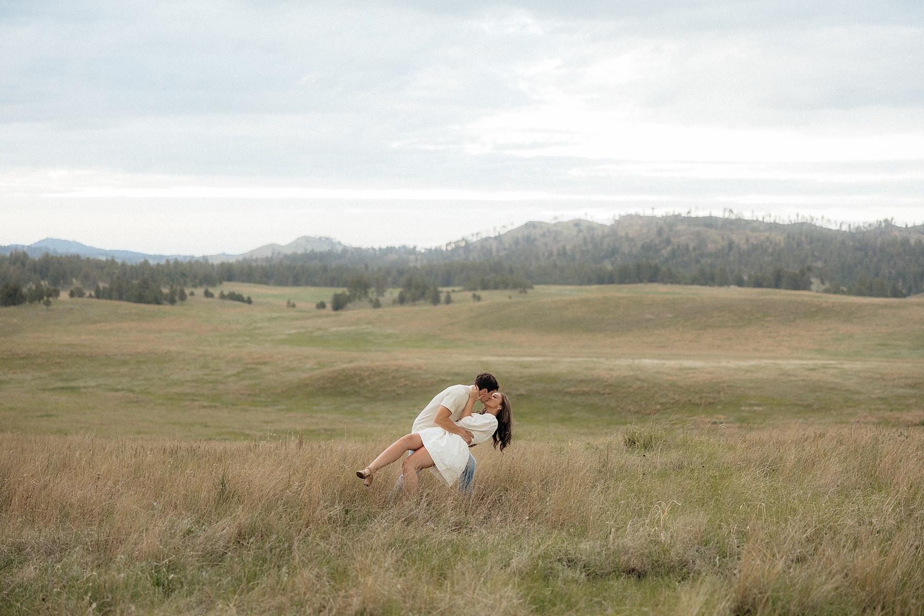 Christian dipping Olivia with the Black Hills in the background.