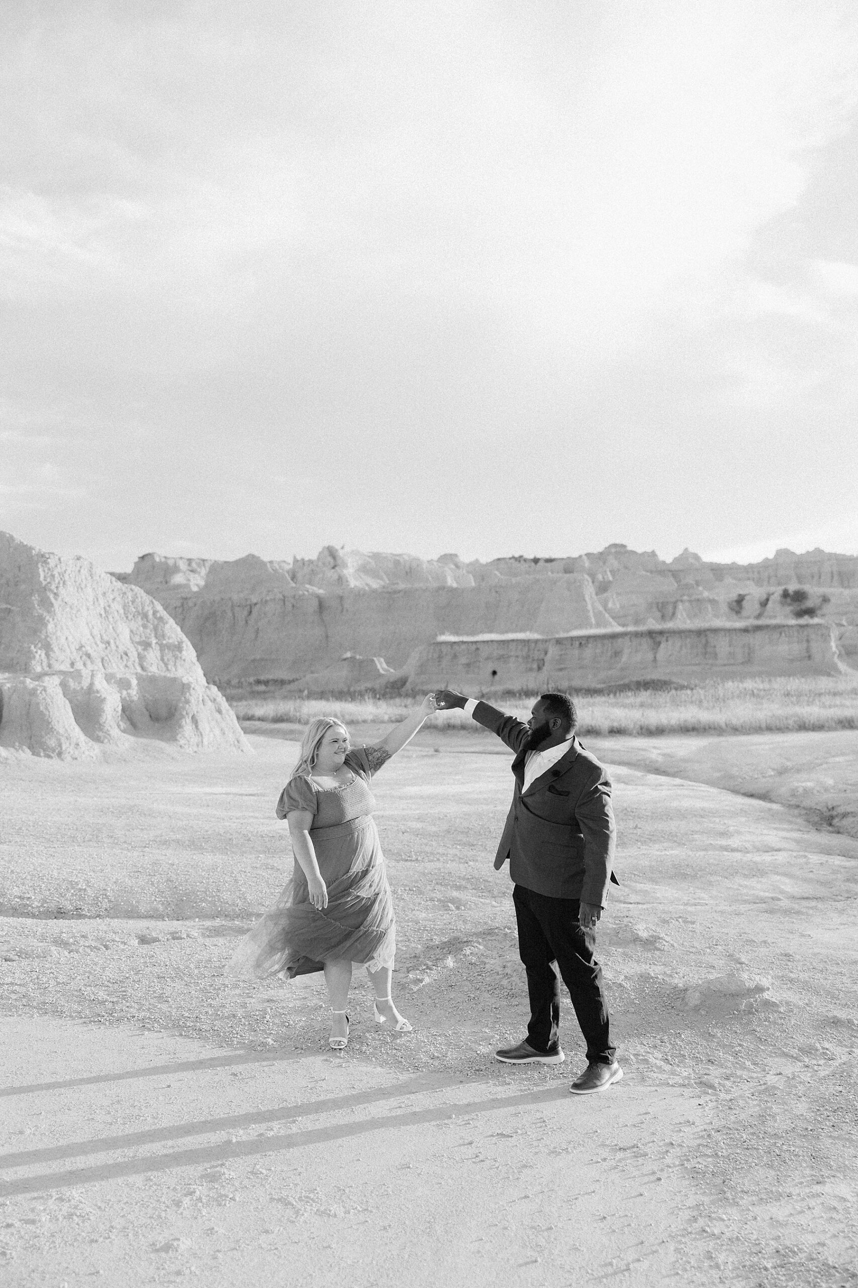 Kenyon spinning BreAnn at their Badlands engagement session.