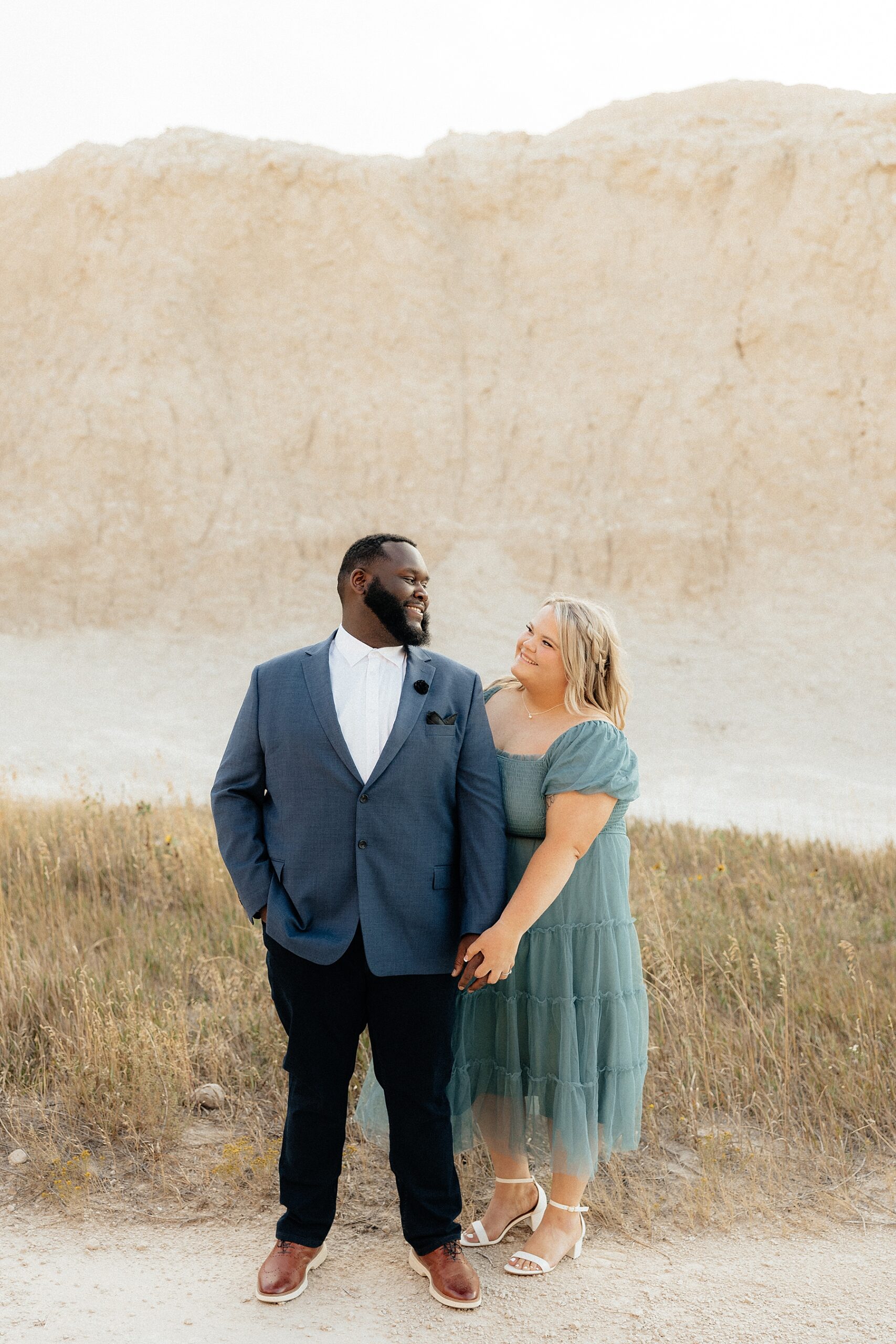 A couple smiling during their Badlands Photos.