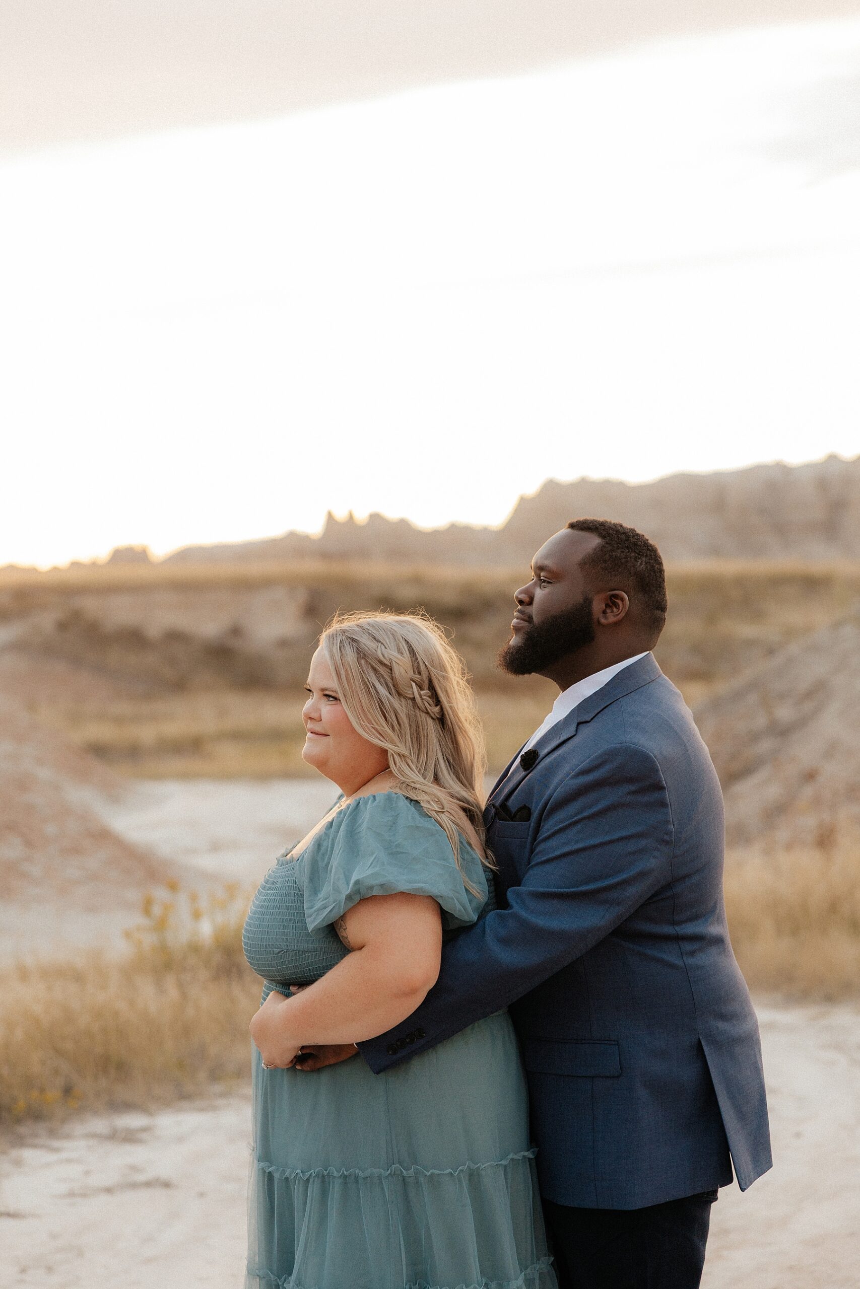 A couple looking off into the distance in the Badlands.