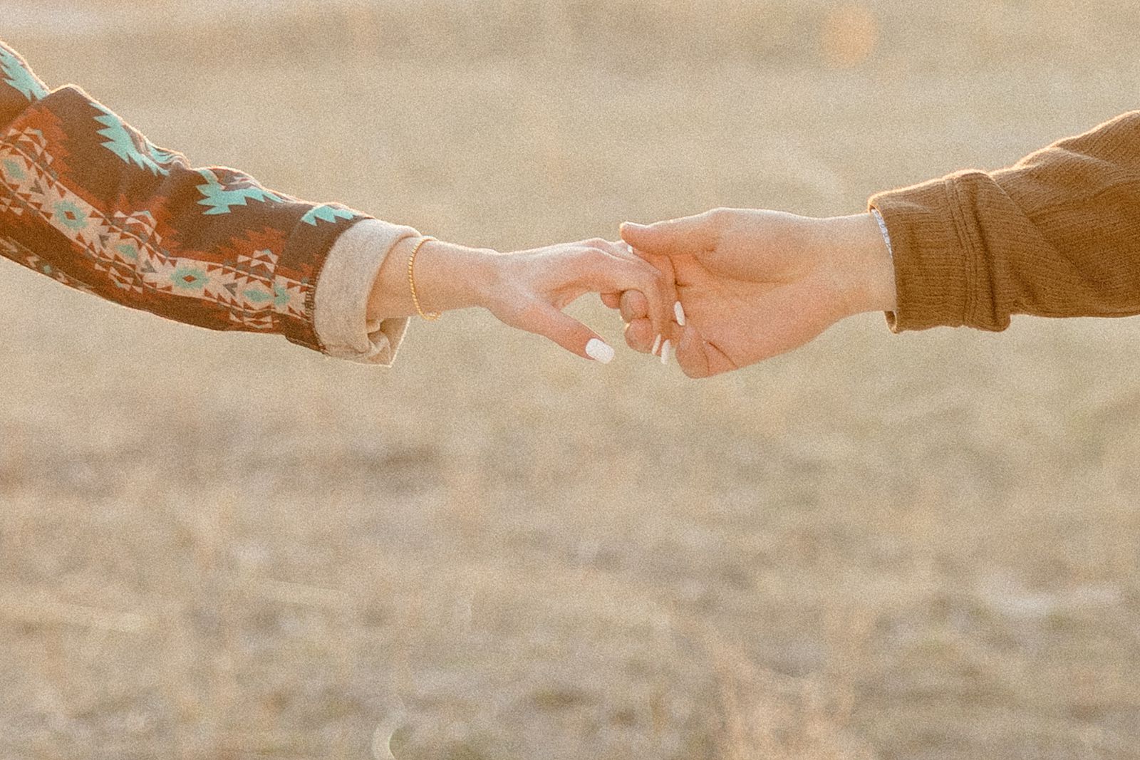 A couple holding hands in the badlands.