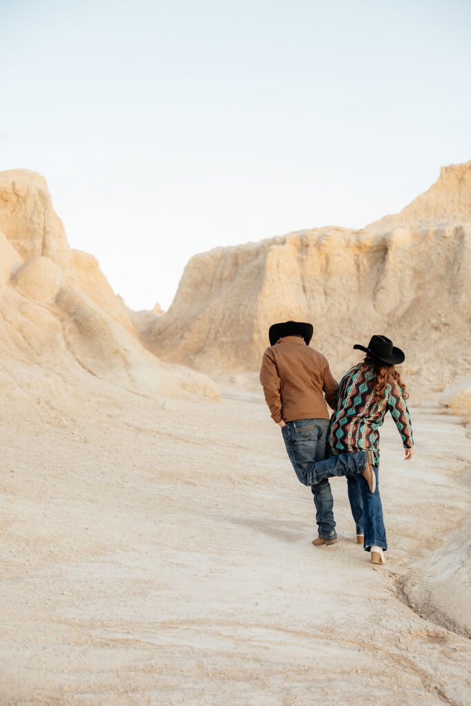 A couple having fun during their badlands engagement session.