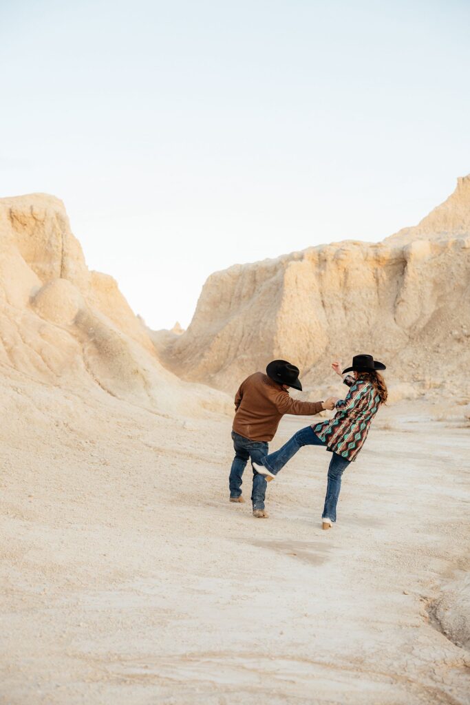 A couple playing during their western engagement session.