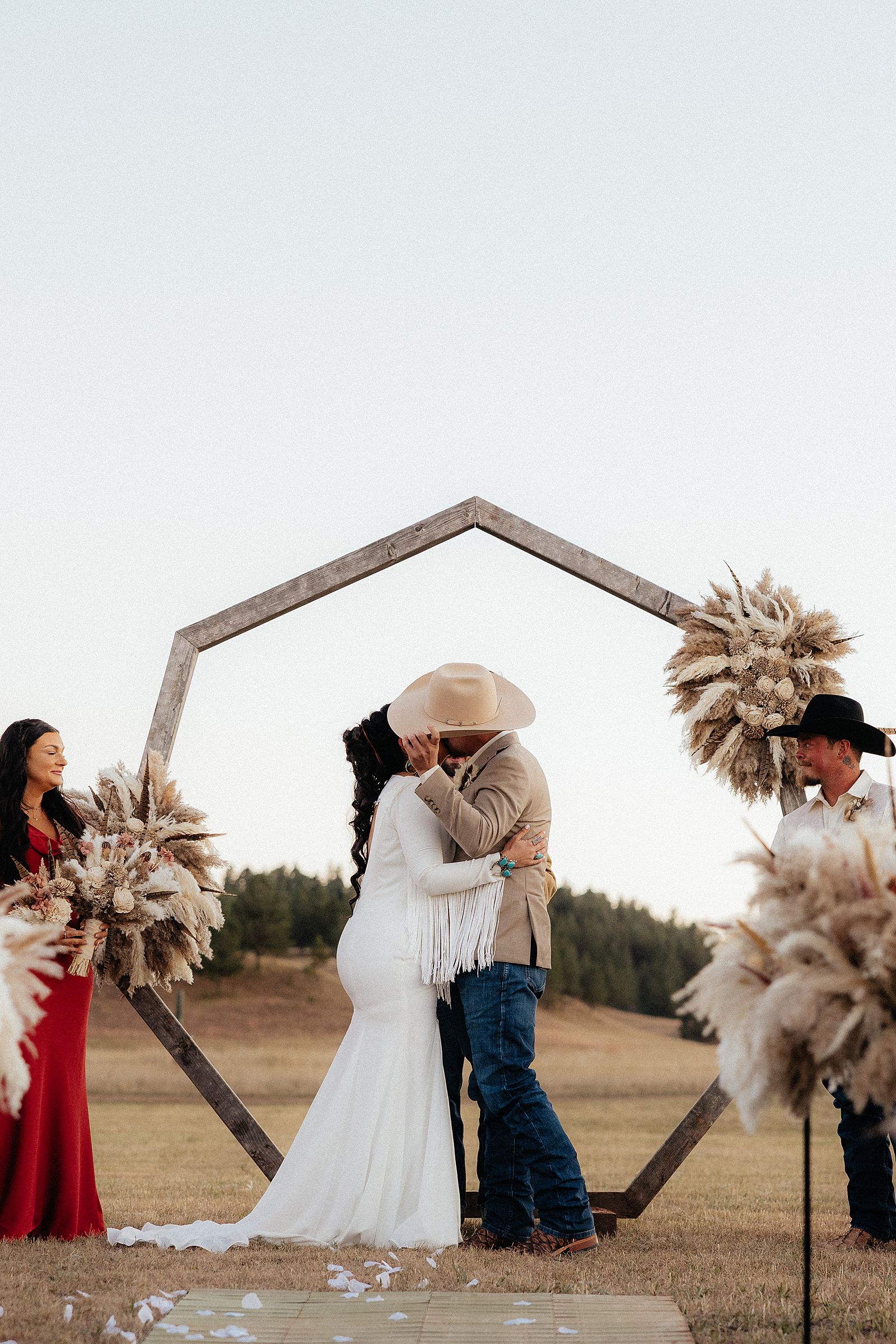 The bride and groom kissing.