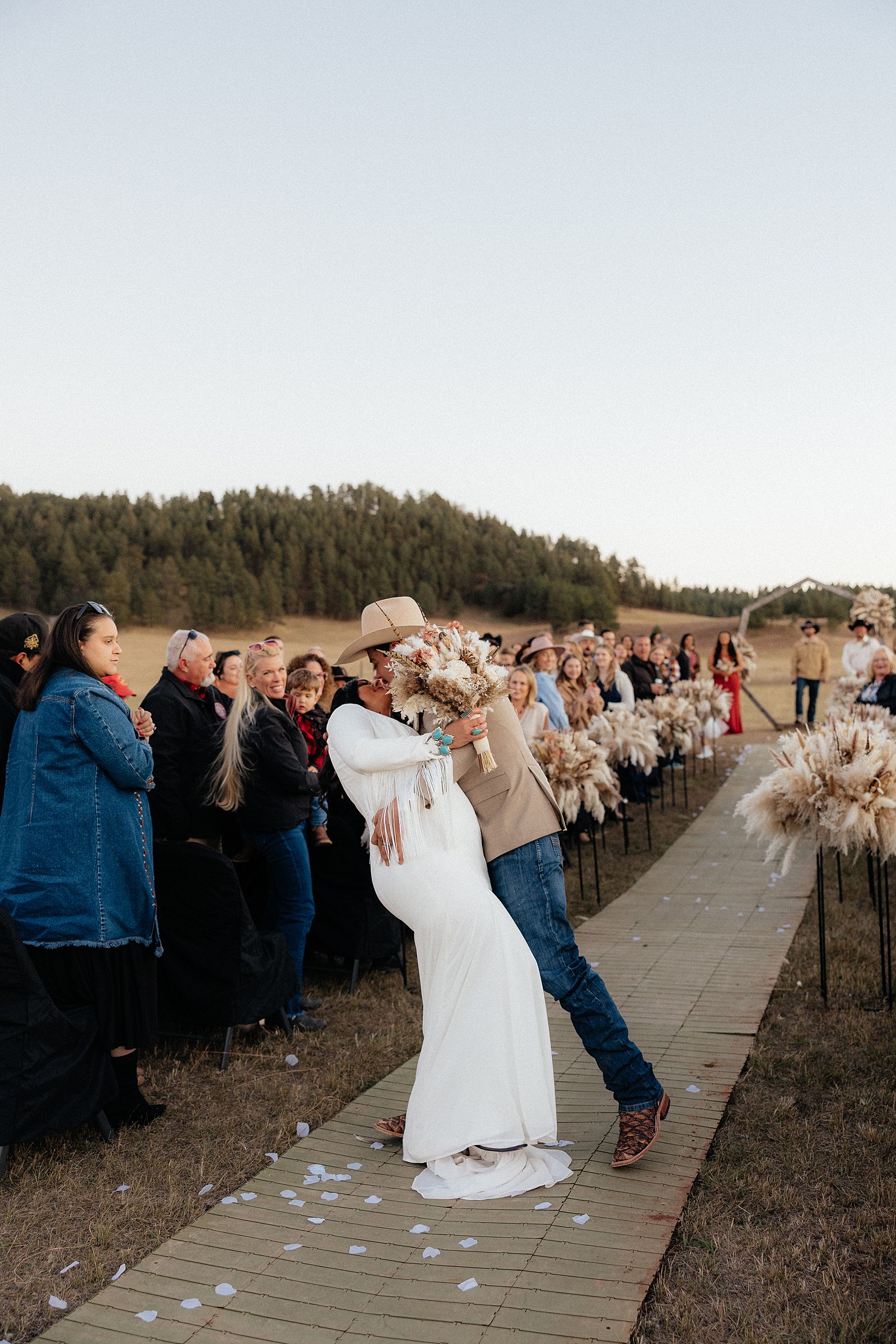 The groom dipping the bride in the aisle at Battle Creek Camping Resort.
