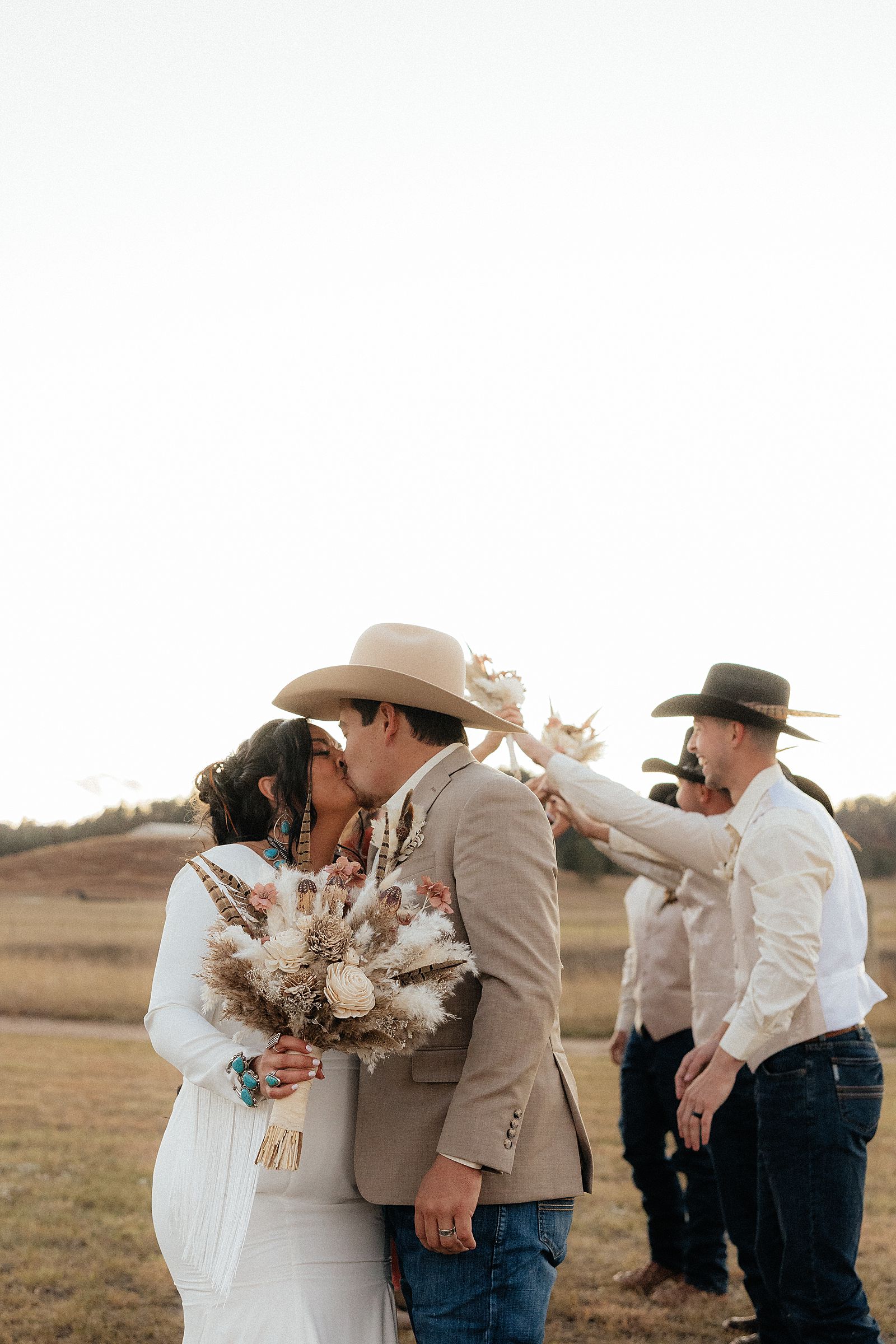 The bride and groom kissing.