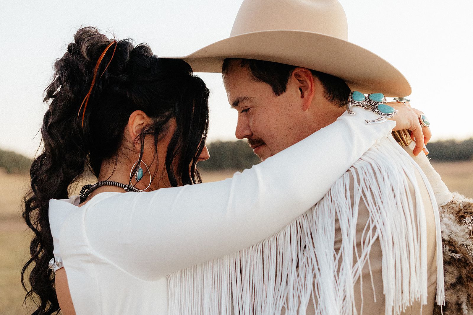 The bride and groom standing forehead to forehead.