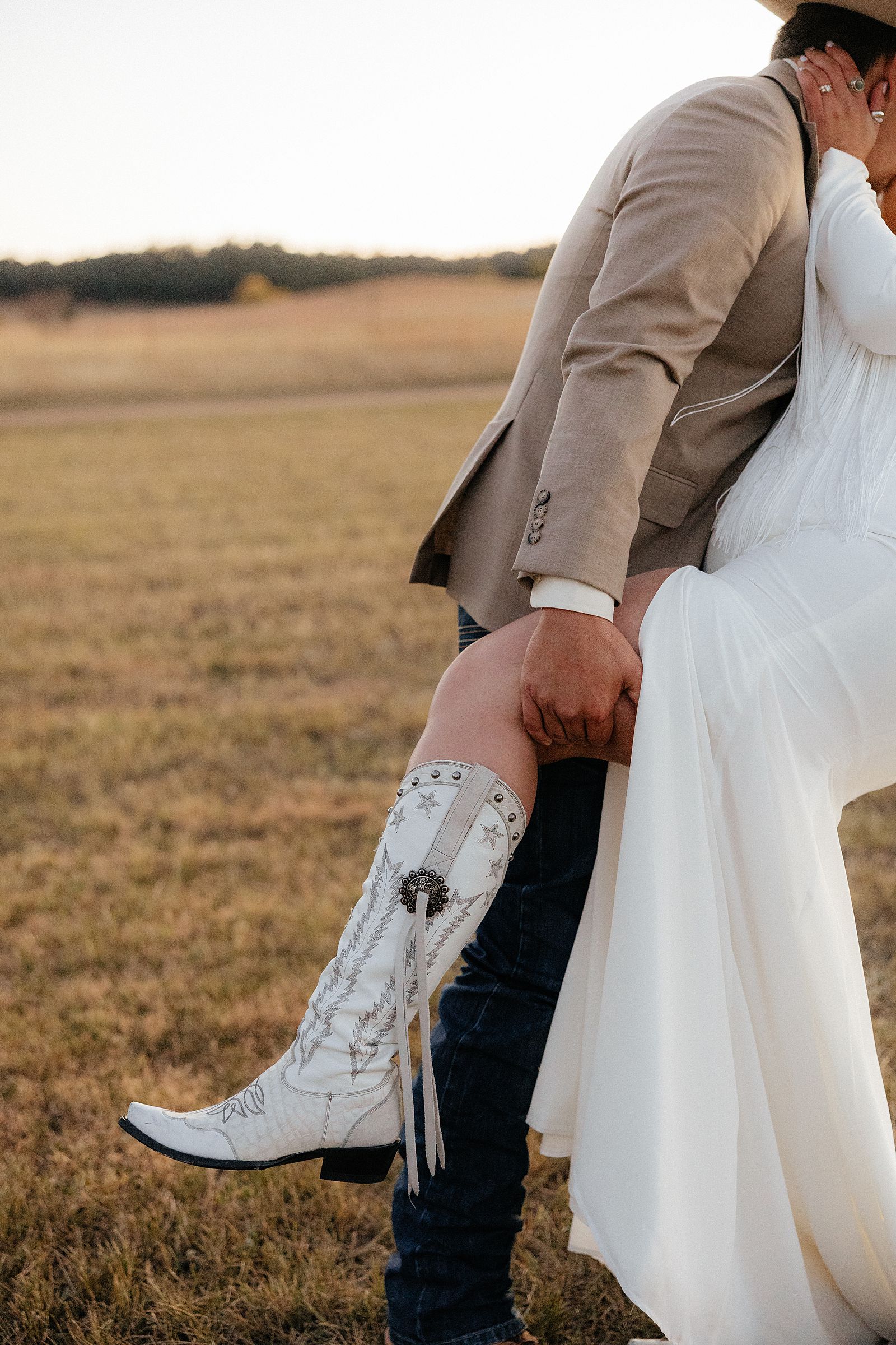 The bride's white wedding cowgirl boots.