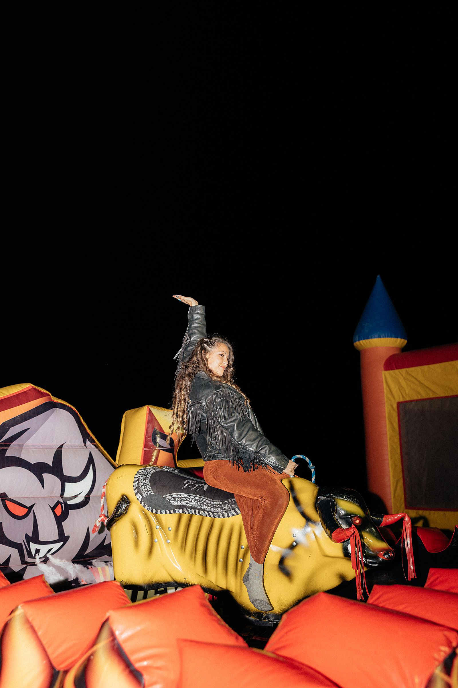 A bridesmaid riding a mechanical bull.
