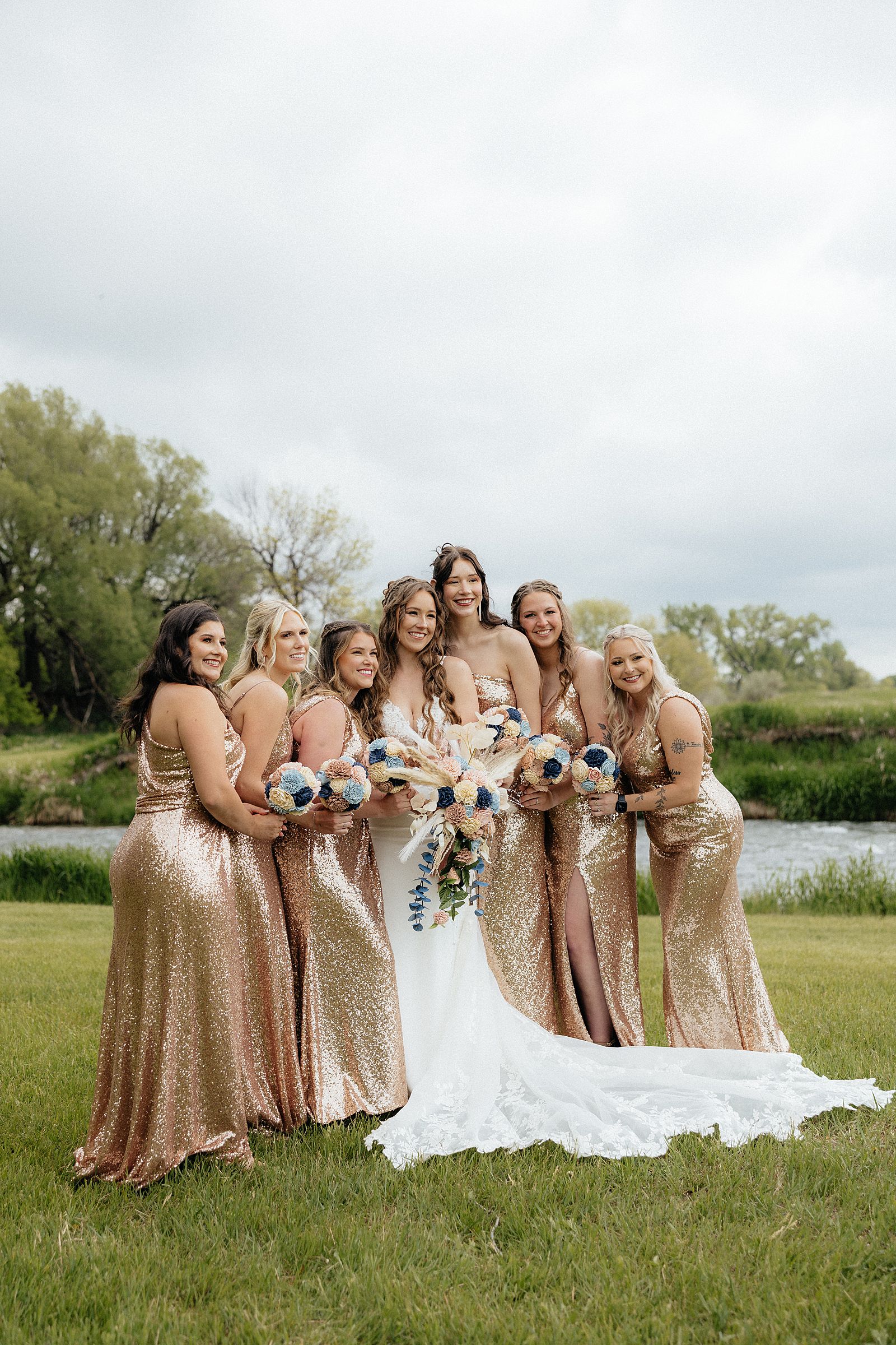 A bride and her bridesmaids in rose gold, sequins dresses.