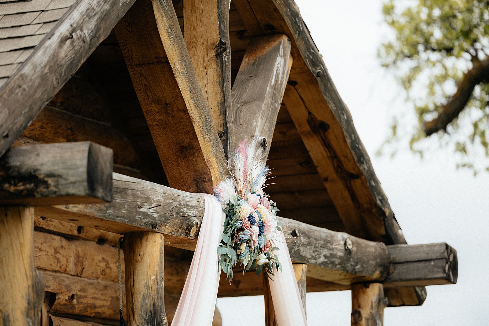 Floral decor on a rustic cabin chapel.