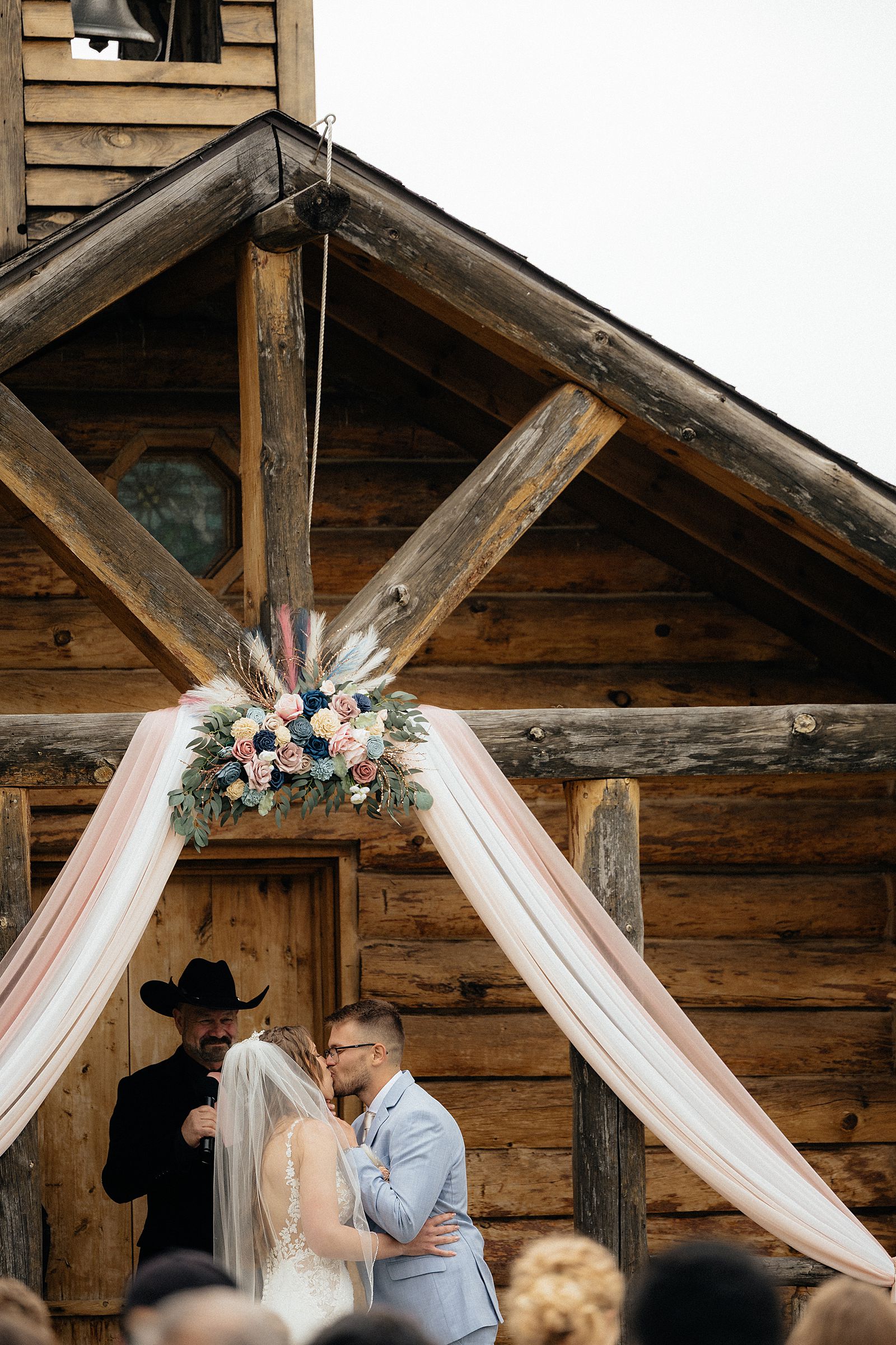 The bride and groom's first kiss in front of the chapel.