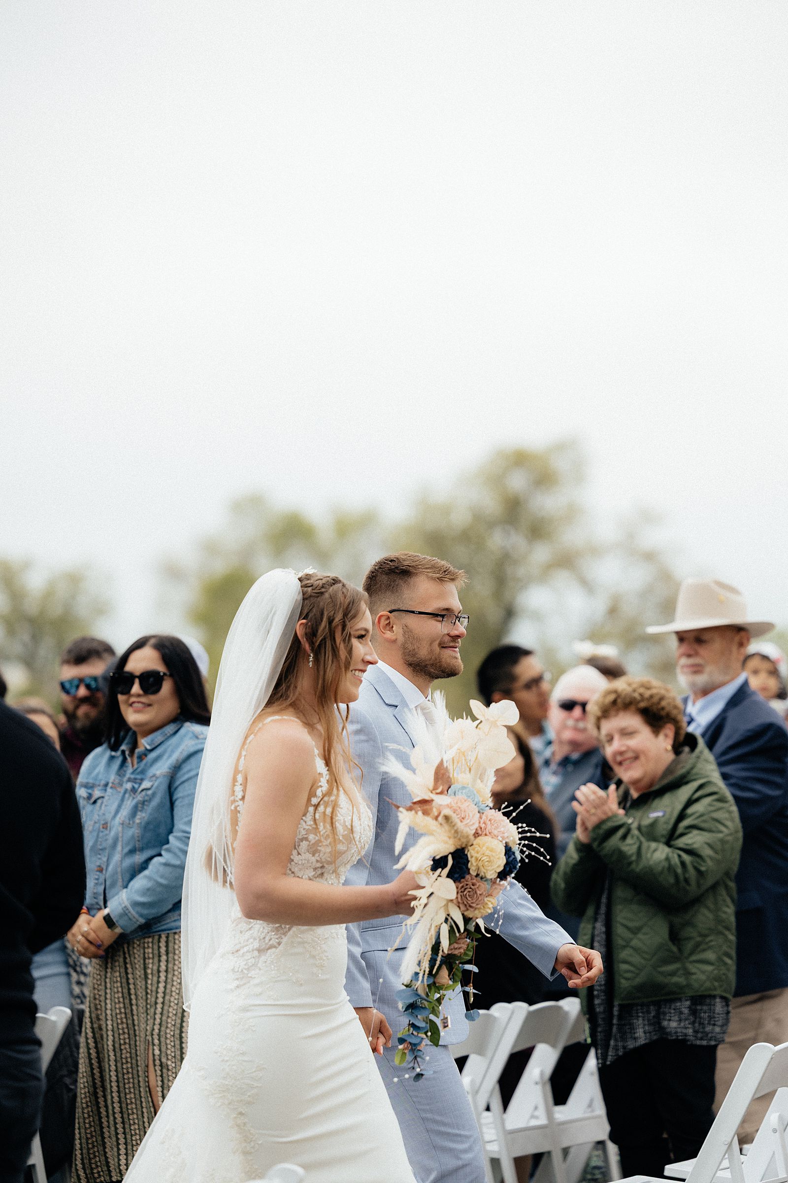 The bride and groom's recessional with the crowd cheering.