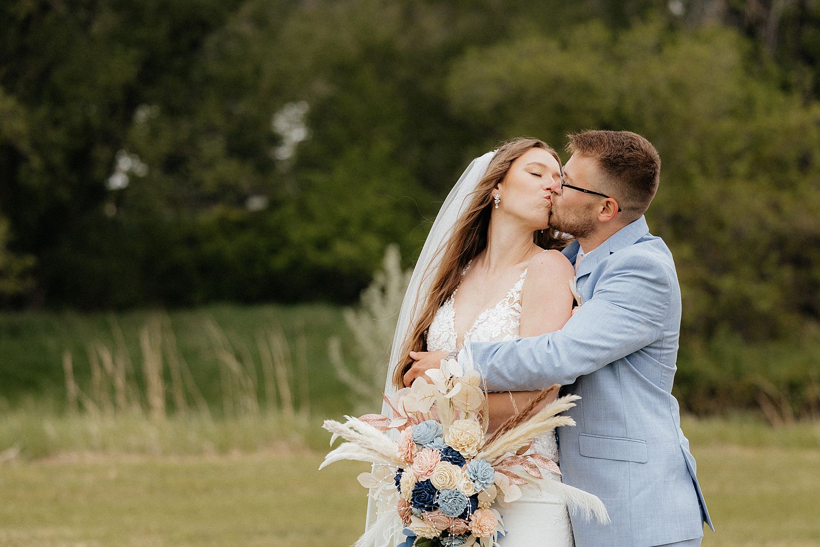 A couple kissing in a field in South Dakota.