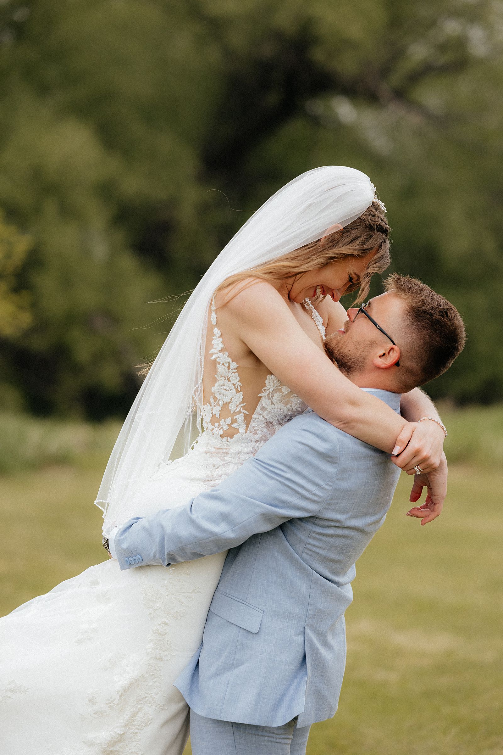 Aryah picking up Grace during their post ceremony portraits.