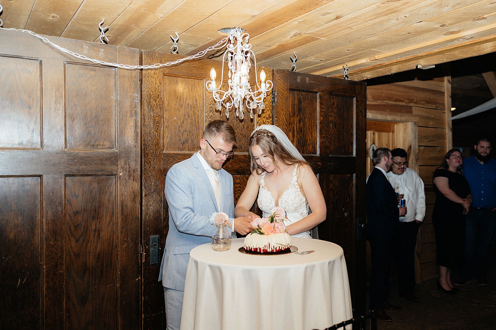 The bride and groom cutting into their cake.