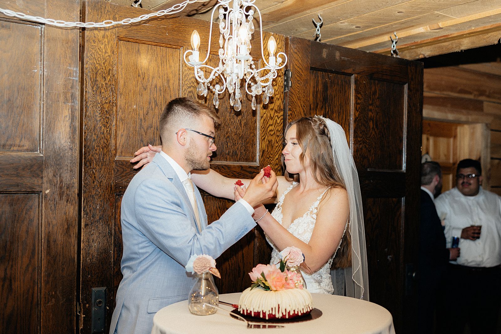 The bride and groom feeding each other cake at Besler's Cadillac Ranch.