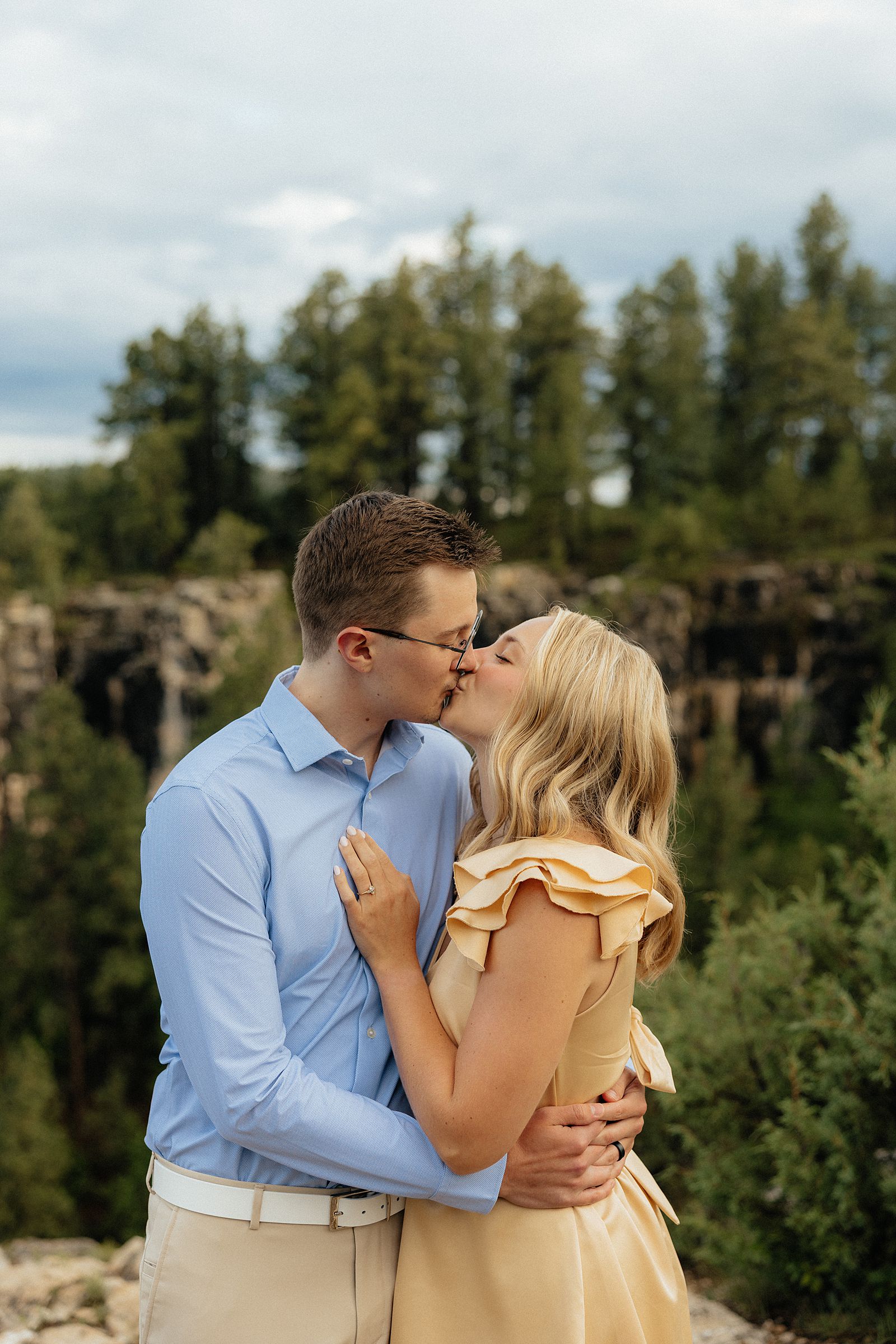 Devin and Avery kissing with the Canyon view behind them.
