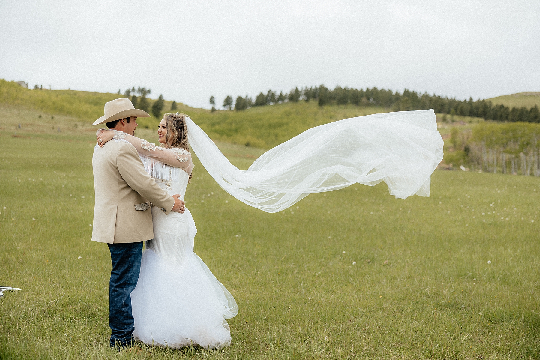 The bride and groom smiling at each other during couple's portraits.