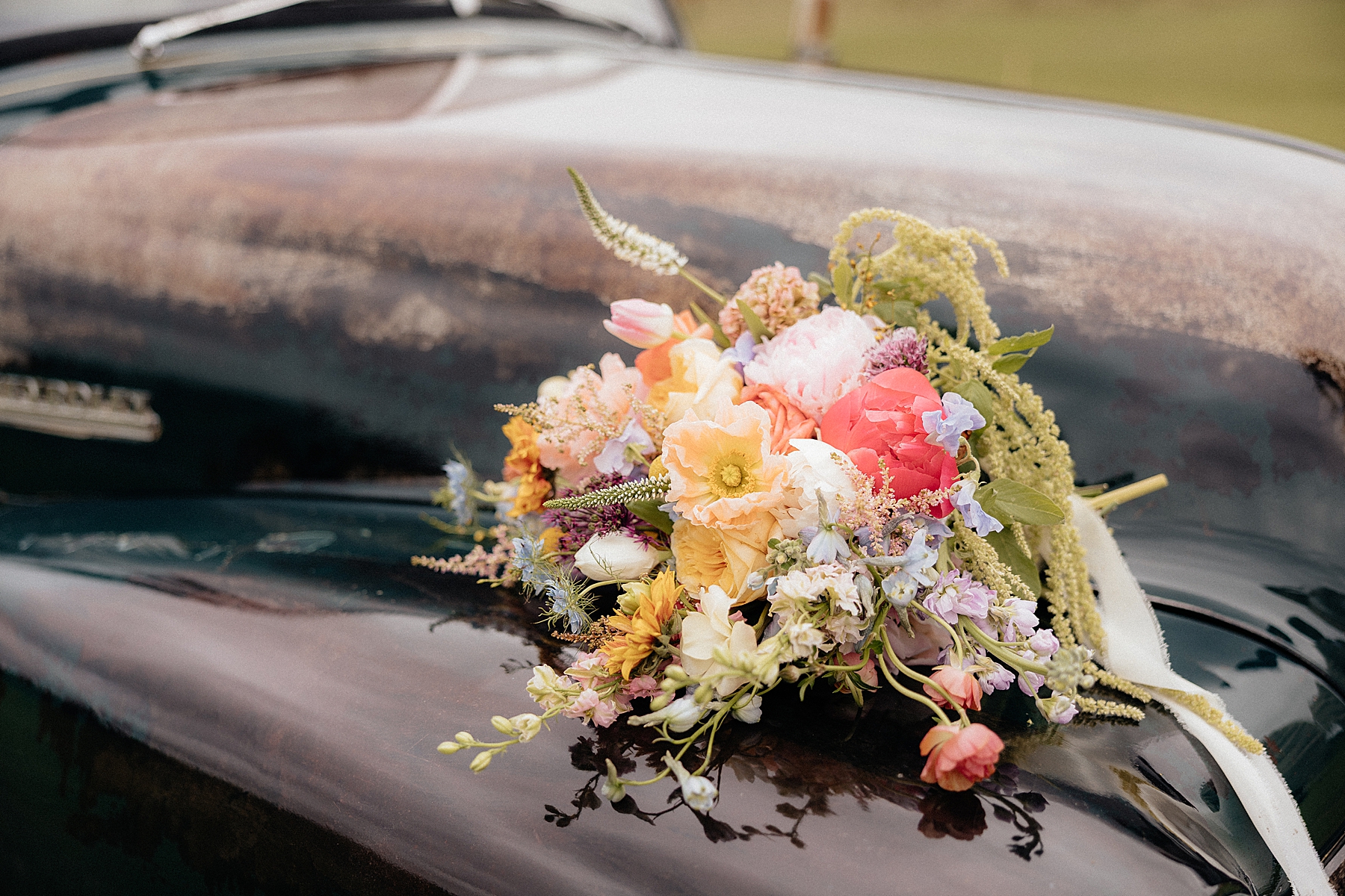 The bride's bouquet on a vintage Chevrolet truck.