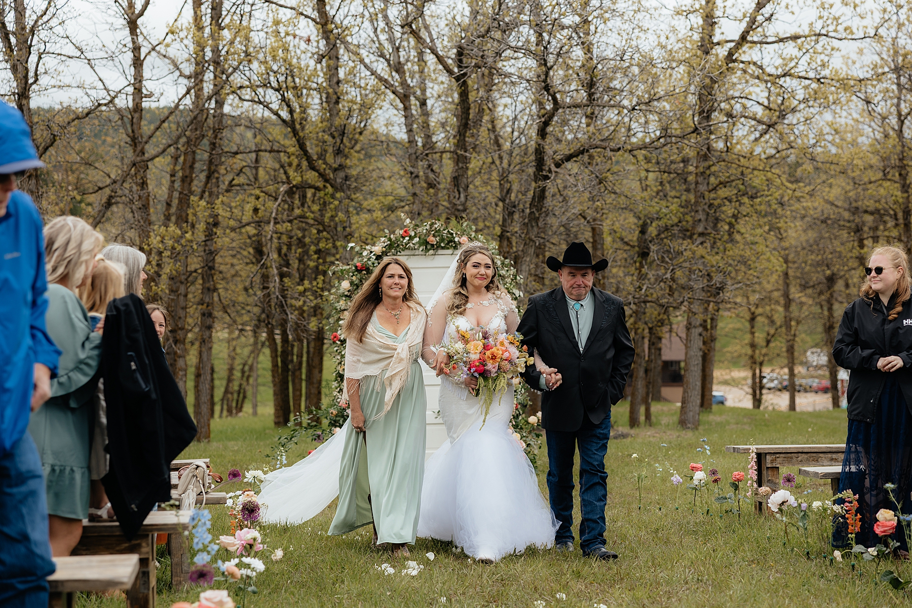 The bride tearing up as she walks down the aisle at Muley Hill Lodge.