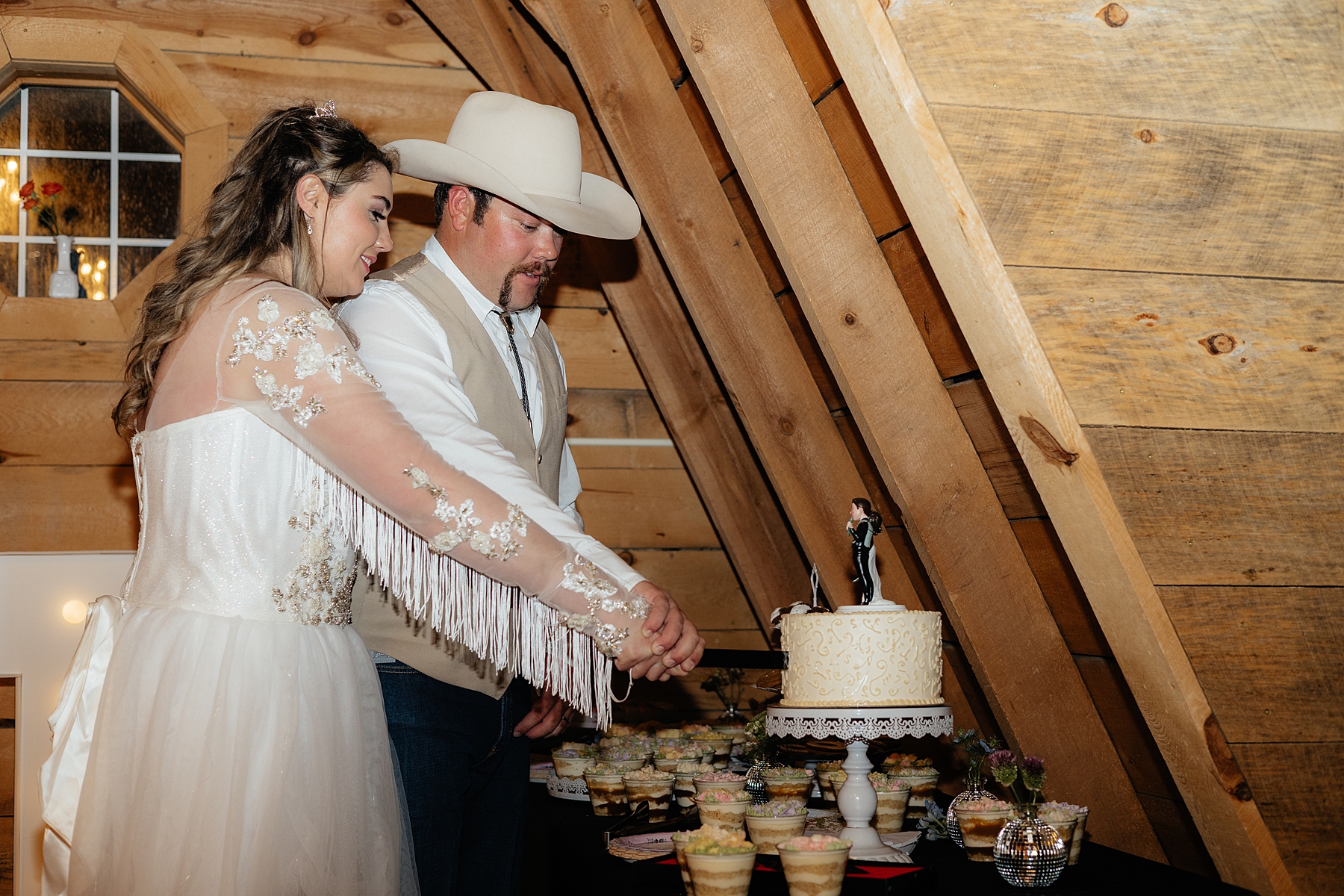 The bride and groom cutting their cake.
