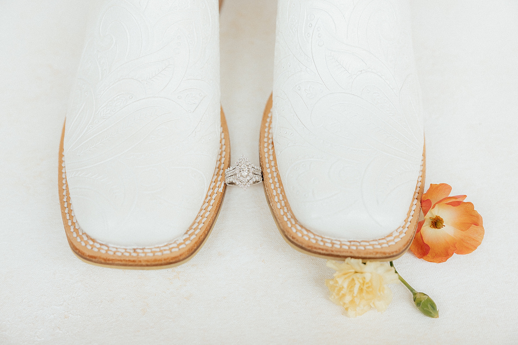 Cowboy boots with a wedding ring.
