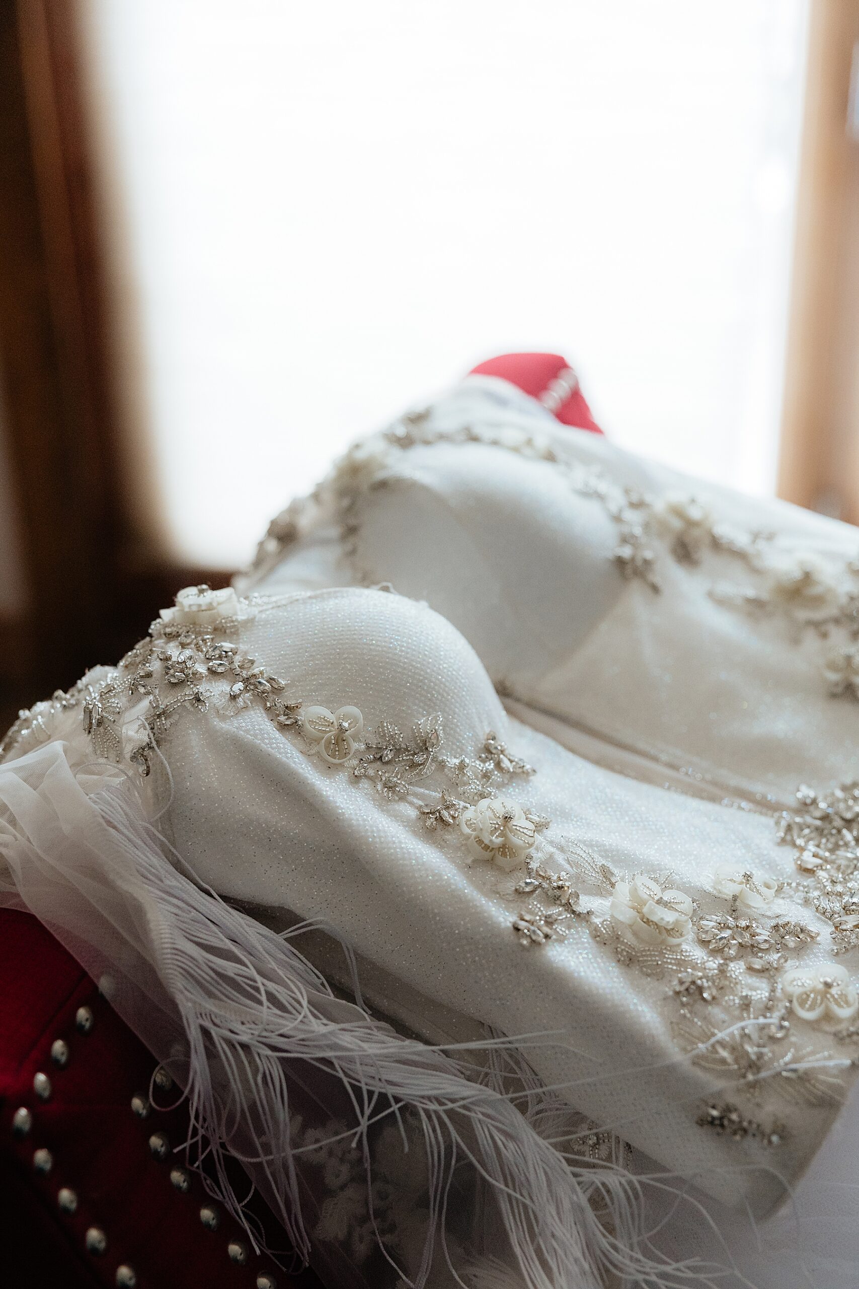 Wedding dress laid down on a chair in the bridal suite at Muley Hill Lodge.