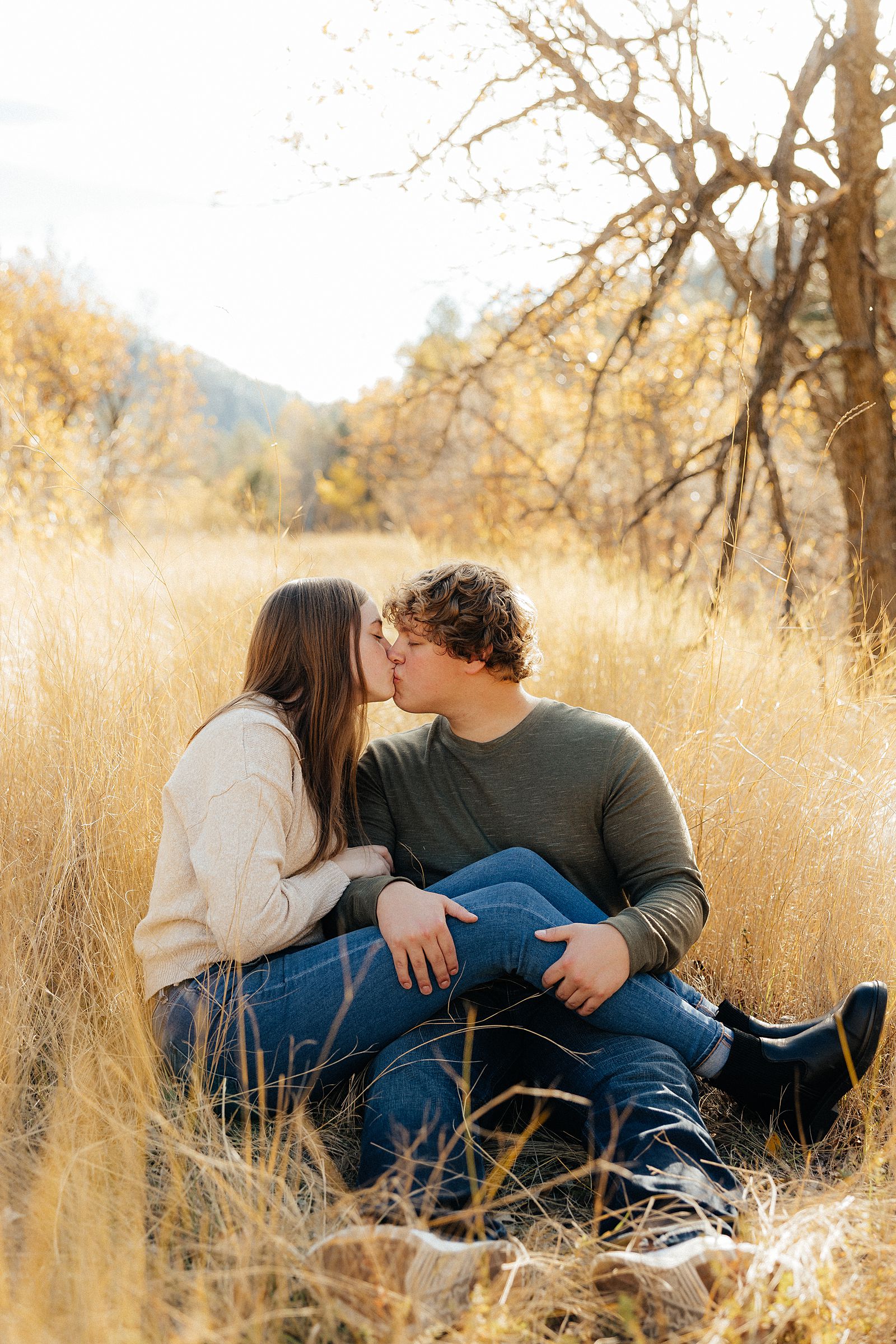 Hannah and Parker kissing on the ground.