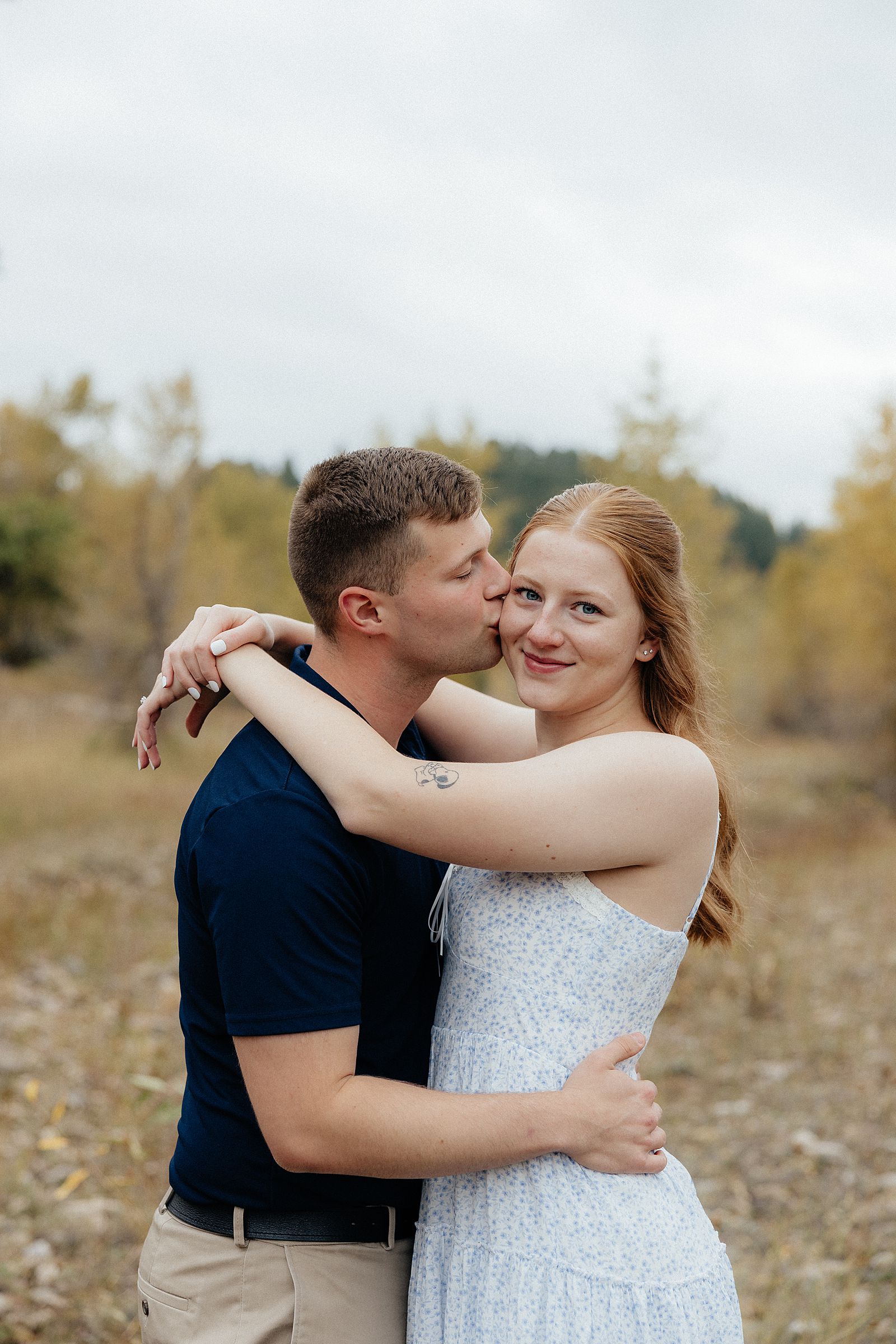 Warren kissing Olivia on the cheek.