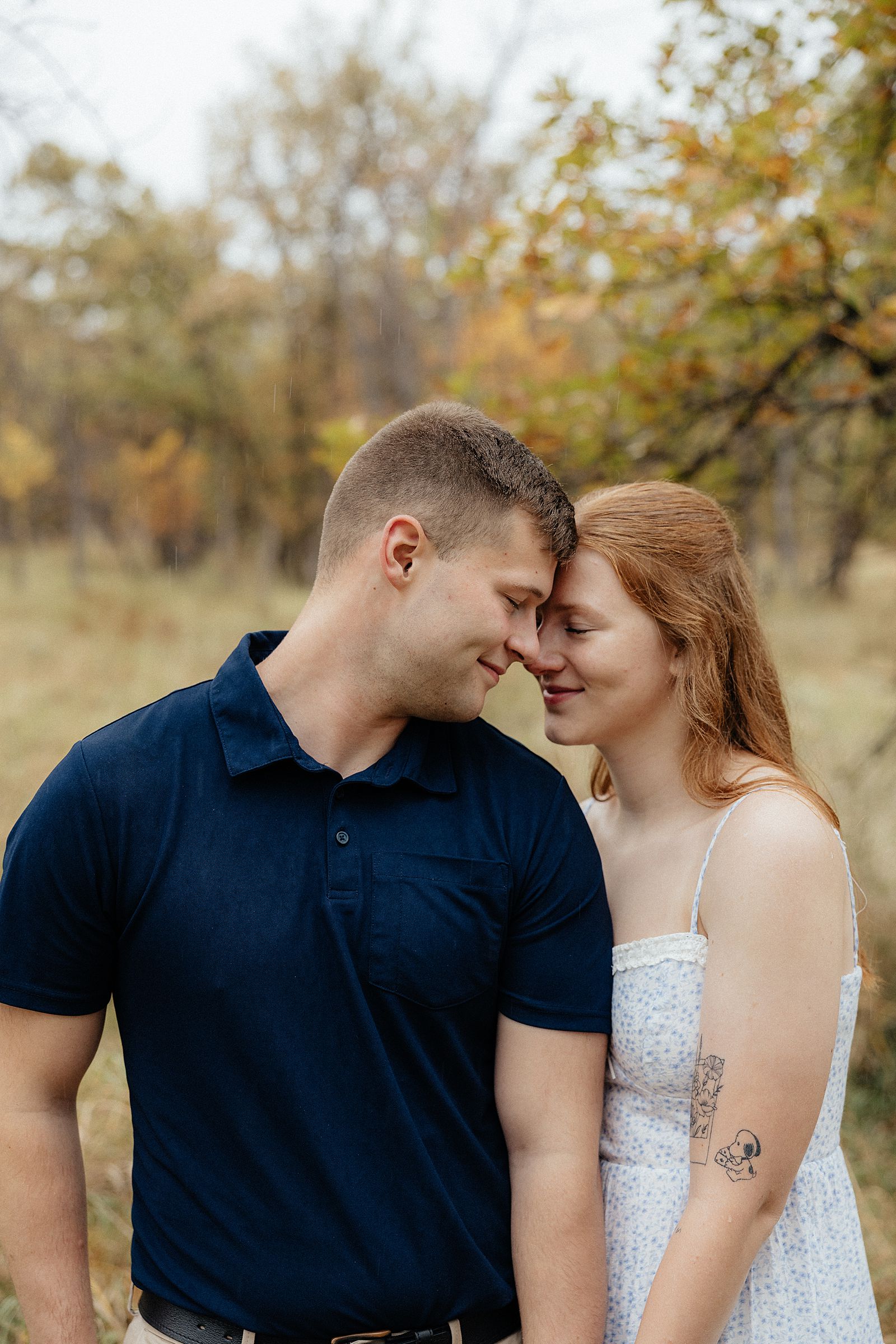 A couple leaning in to each other.