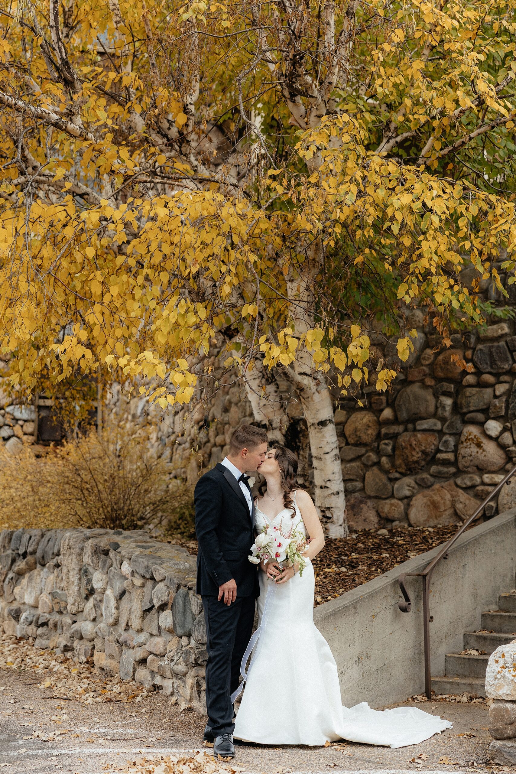 A couple kissing in front of the State Game Lodge.