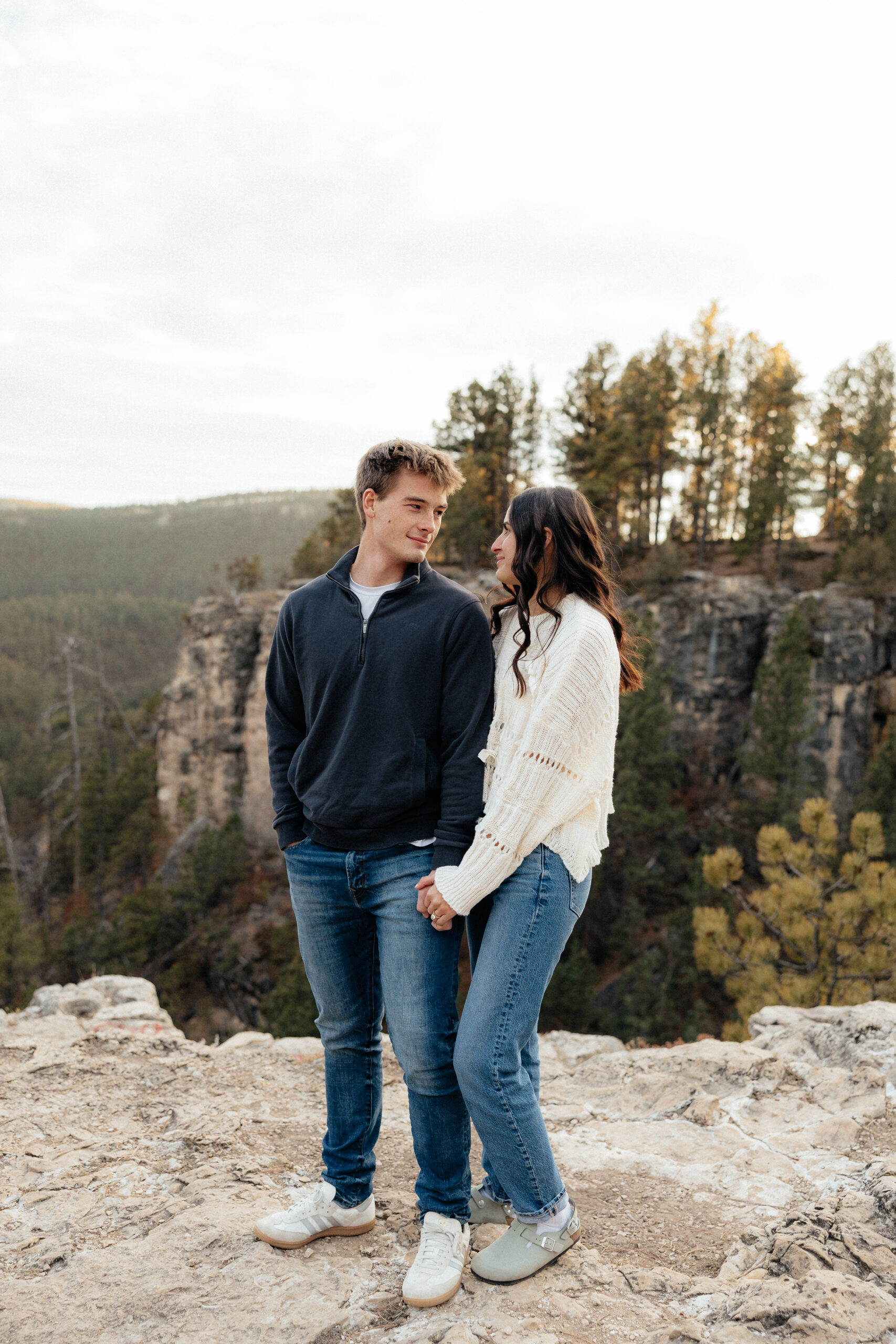 A couple looking at each other at Golden Hour at their South Dakota Engagement Session.