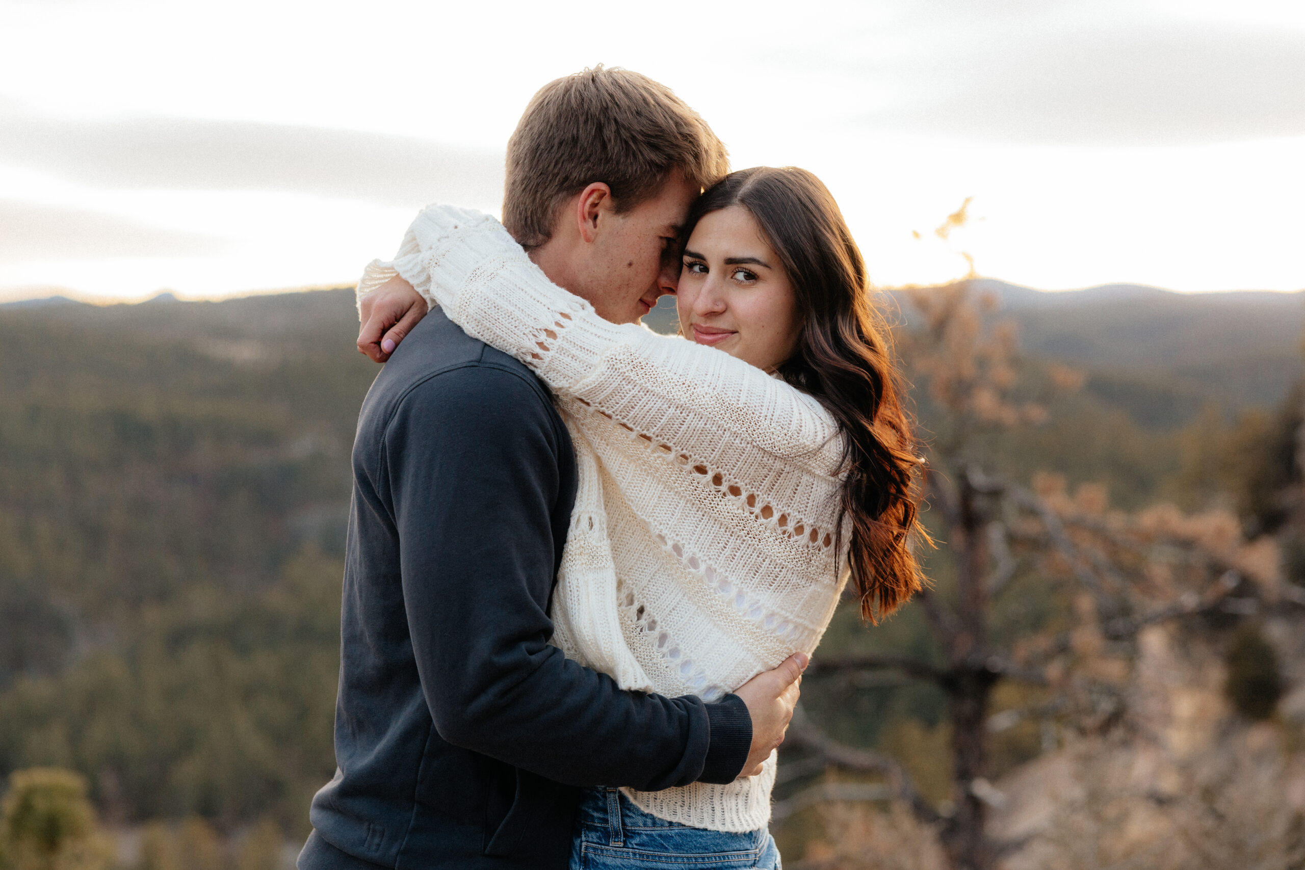 Sam nuzzling Savanah with the Black Hills in the background.