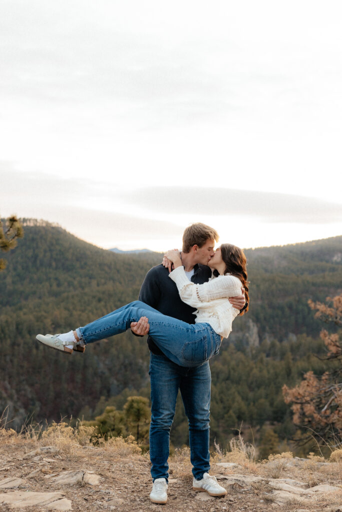 Sam holding Savanah and kissing her.