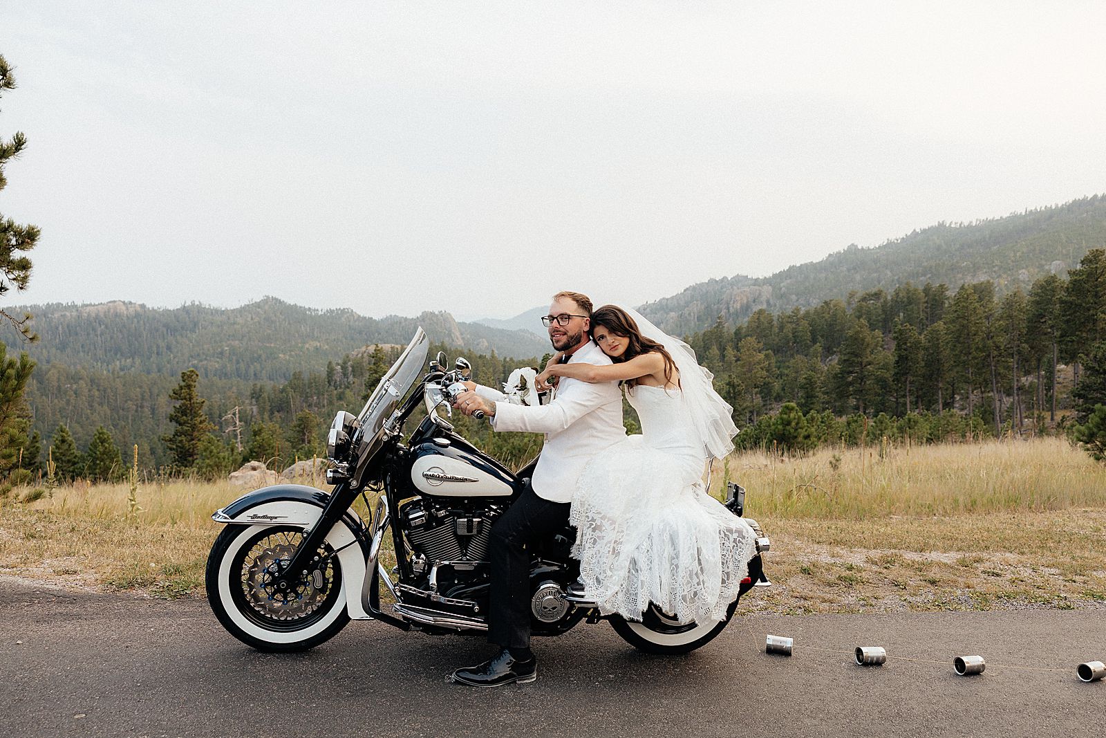 Phoebe and CJ posing with their motorcycle after their Sylvan Lake elopement