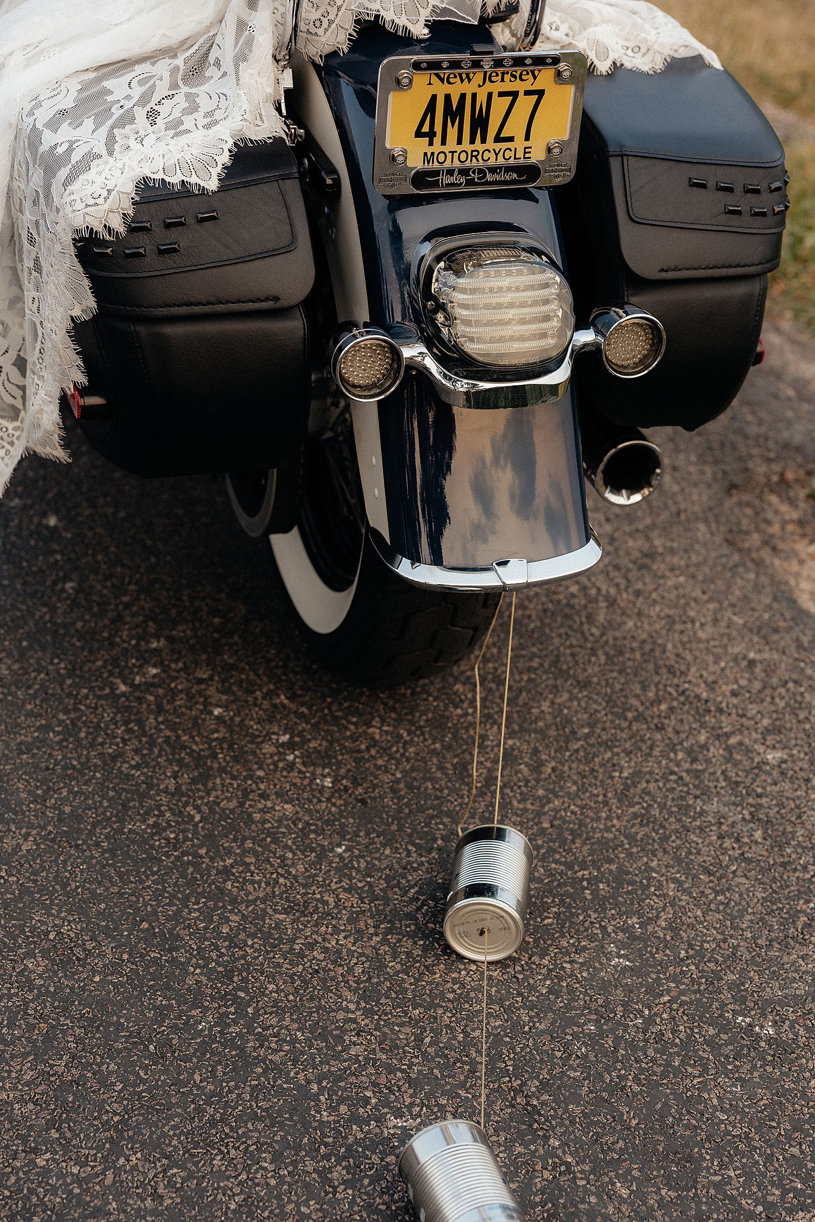 Tin cans hooked to the back of a motorcycle