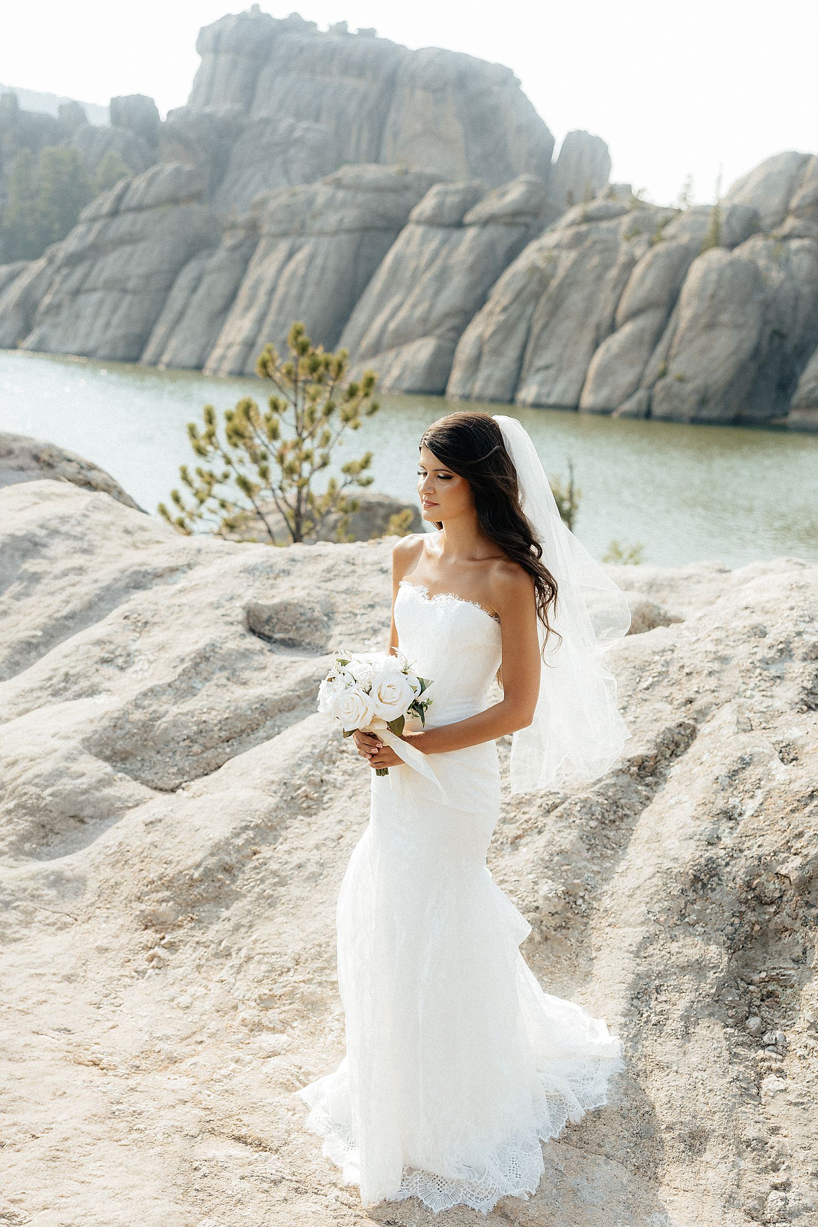Couple exchanging vows surrounded by granite formations and pine trees at Sylvan Lake