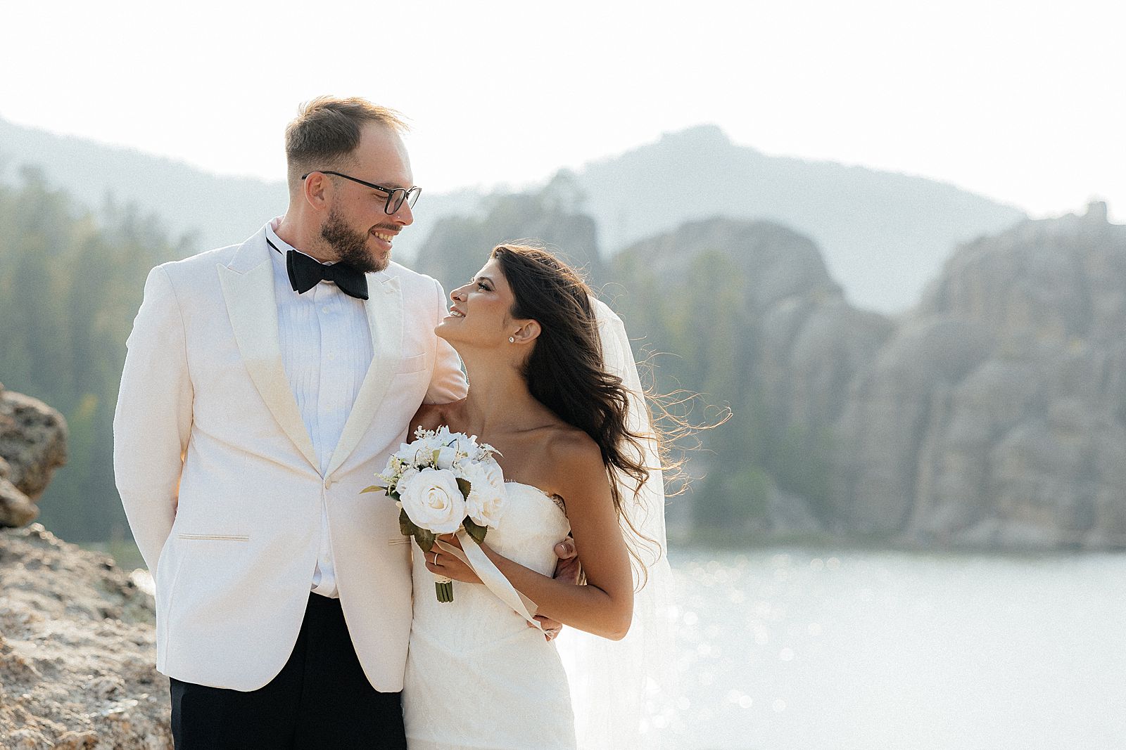 Scenic Sylvan Lake elopement portrait surrounded by water, granite, and pine trees