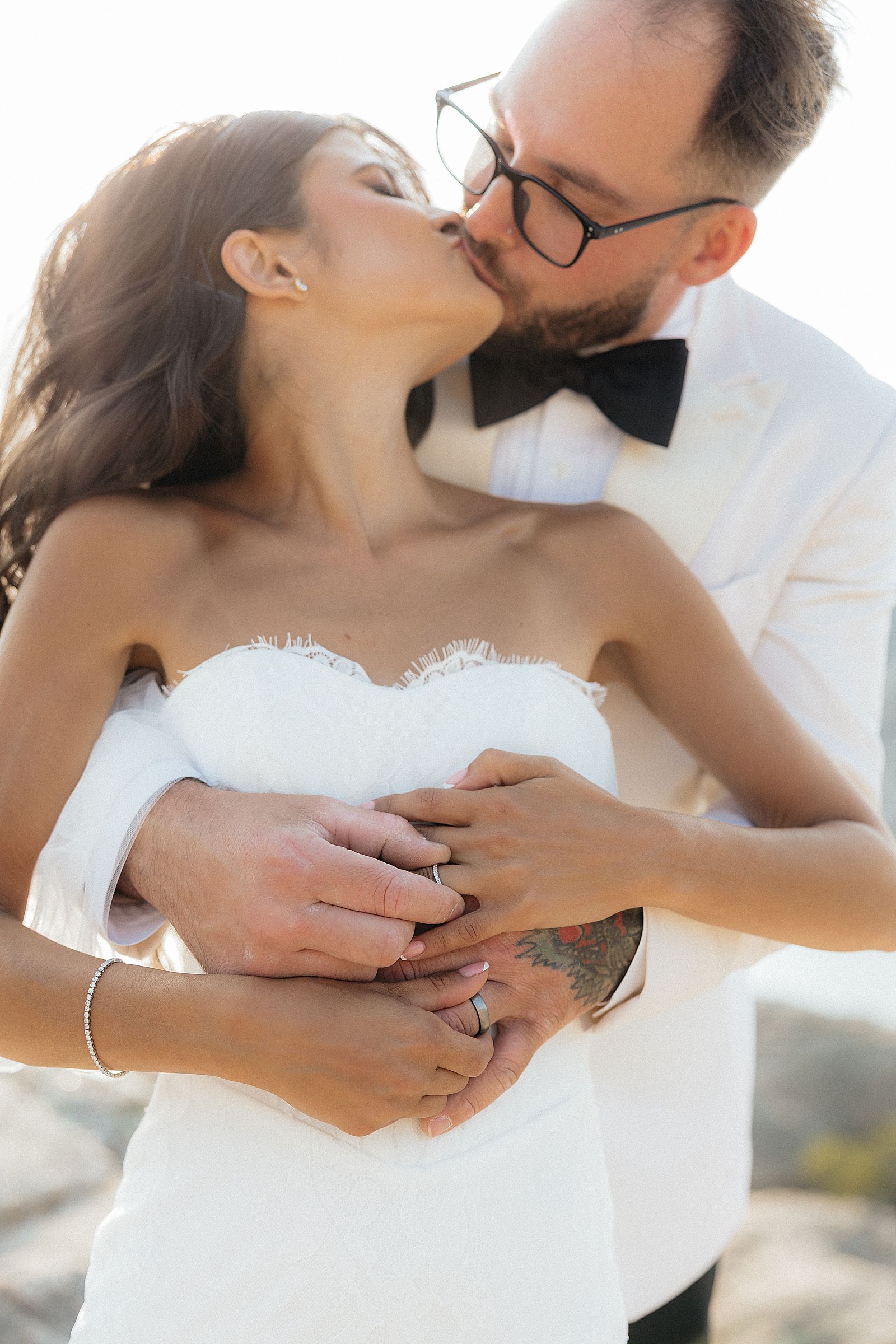 Phoebe and CJ kissing while exchanging rings at their Sylvan Lake elopement